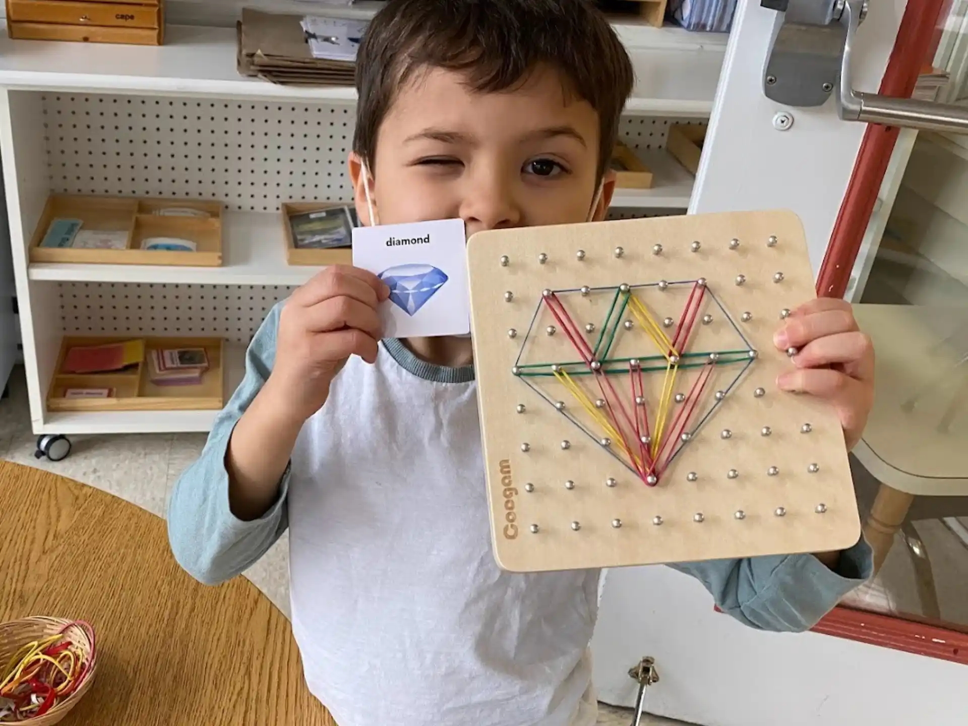 a boy holding a picture of a house