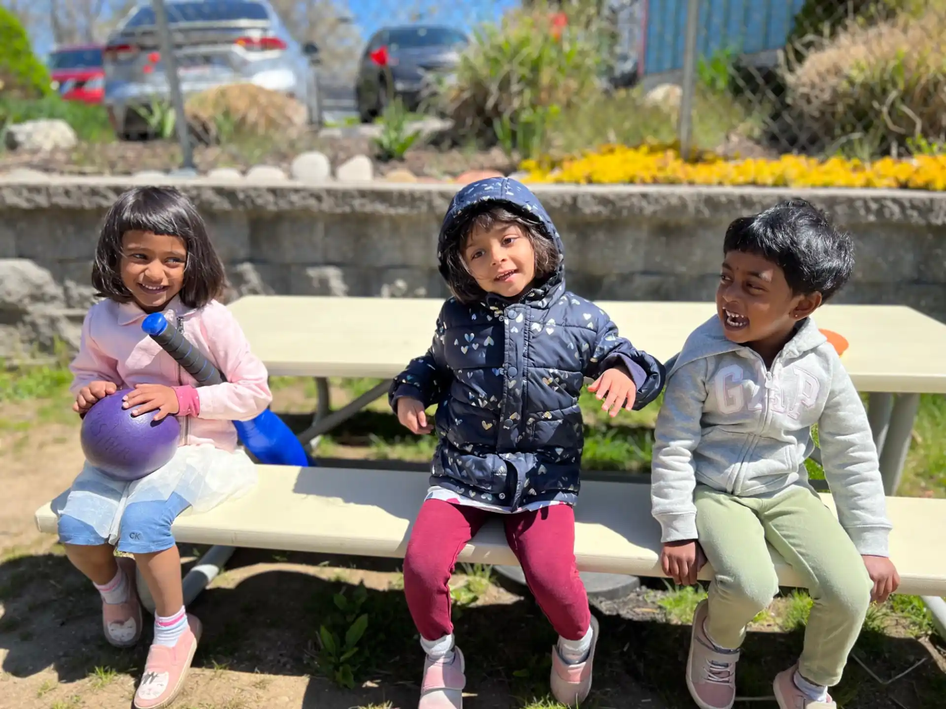 a group of children sitting on a bench