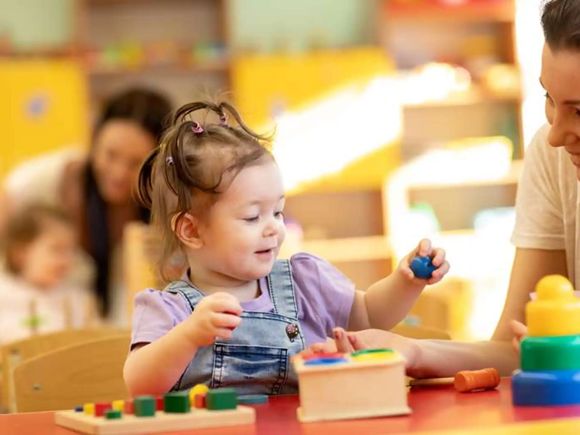 a young girl playing with a toy