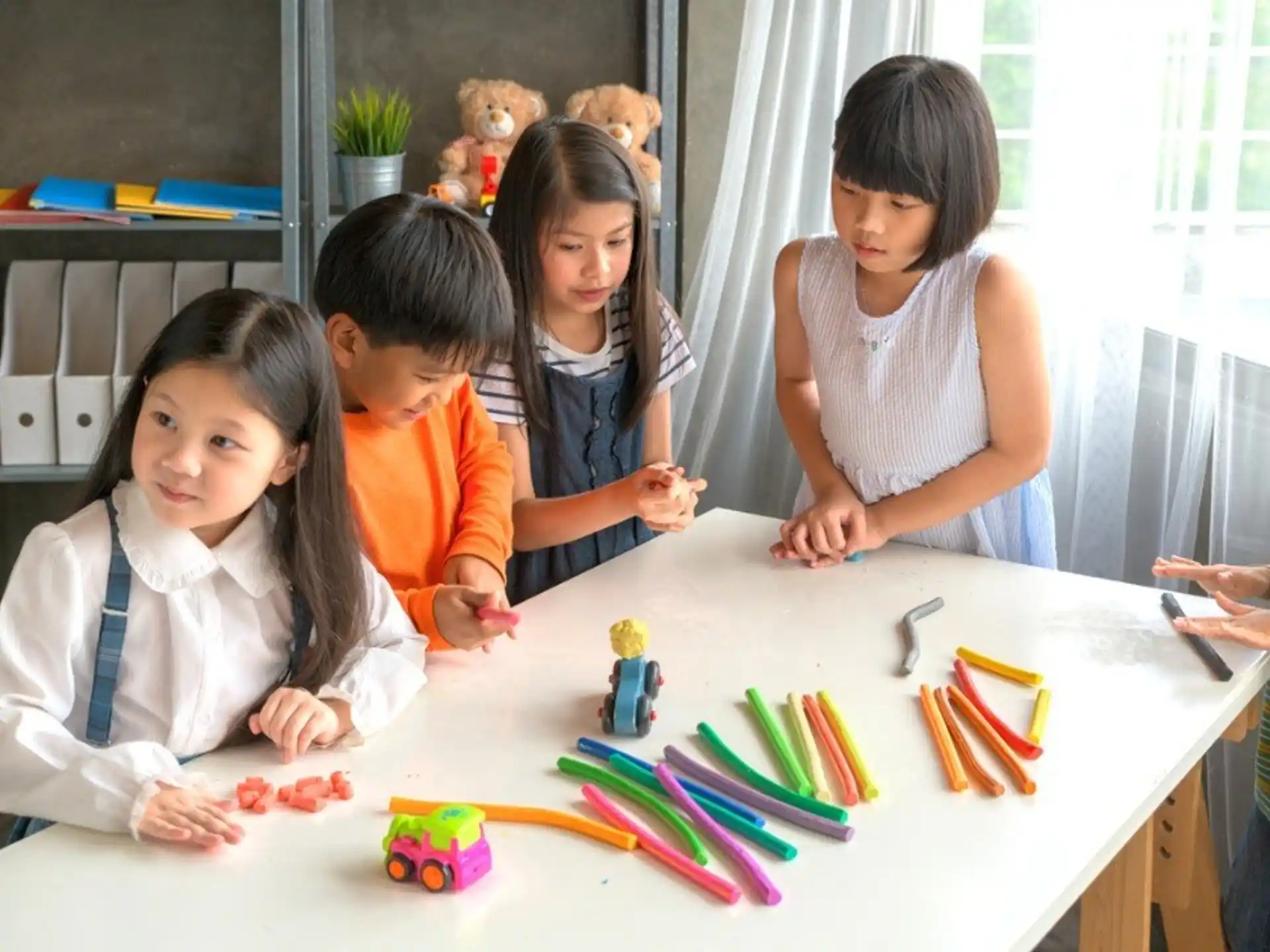 a group of children sitting around a table