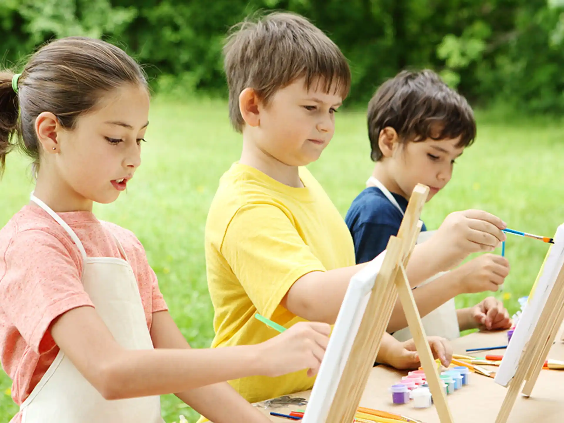 a group of children sitting on a bench outside