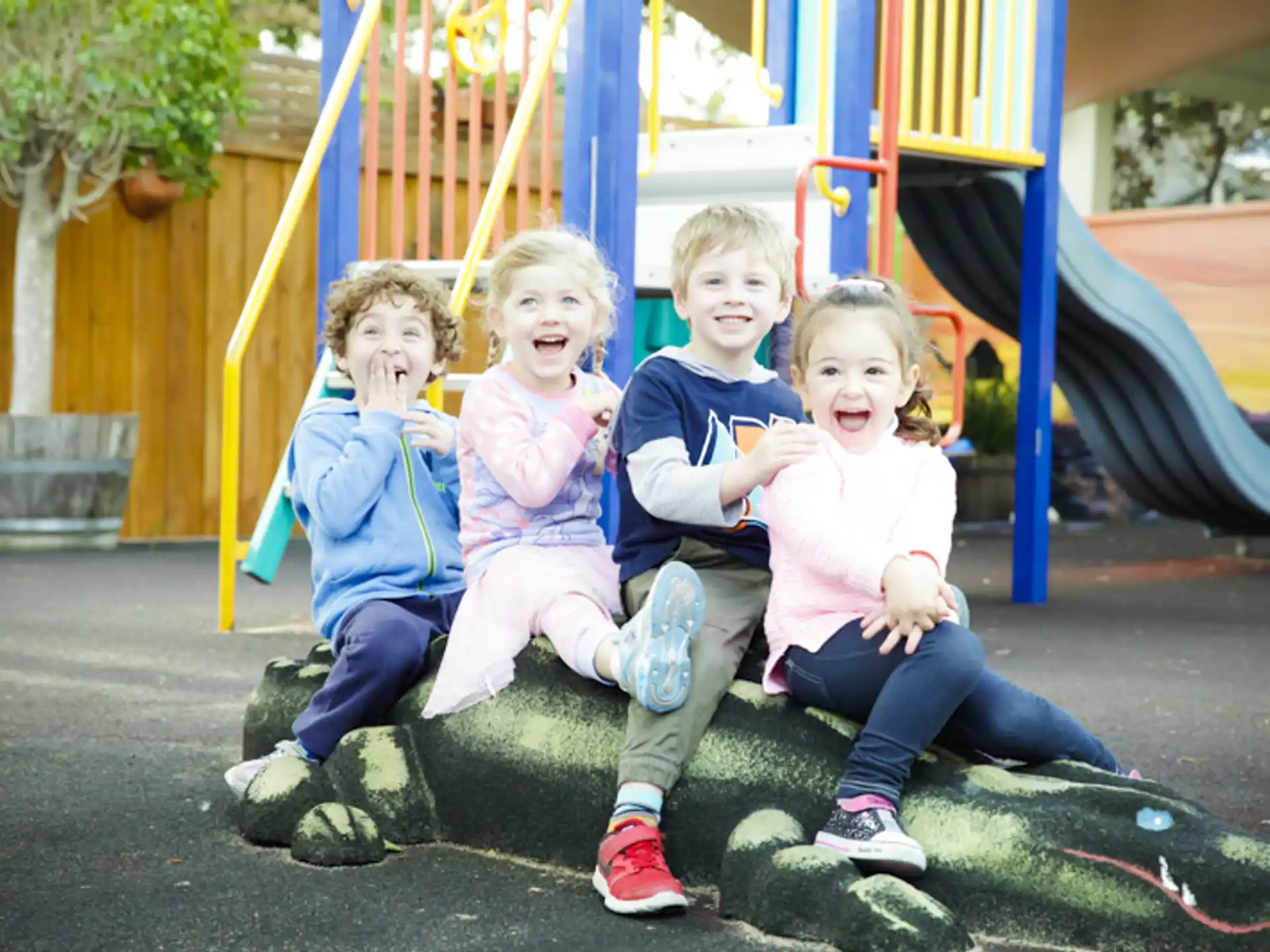 a group of children sitting on a swing
