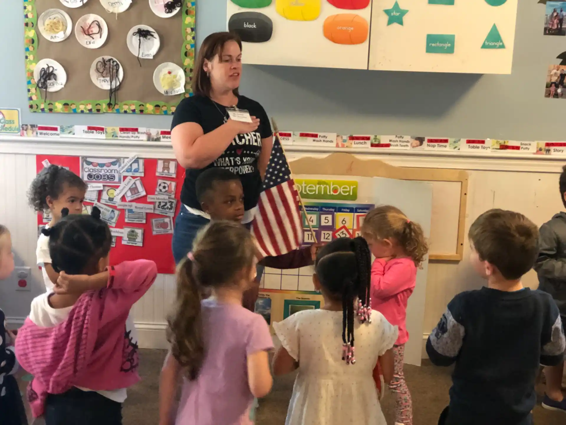 a person standing in front of a group of children