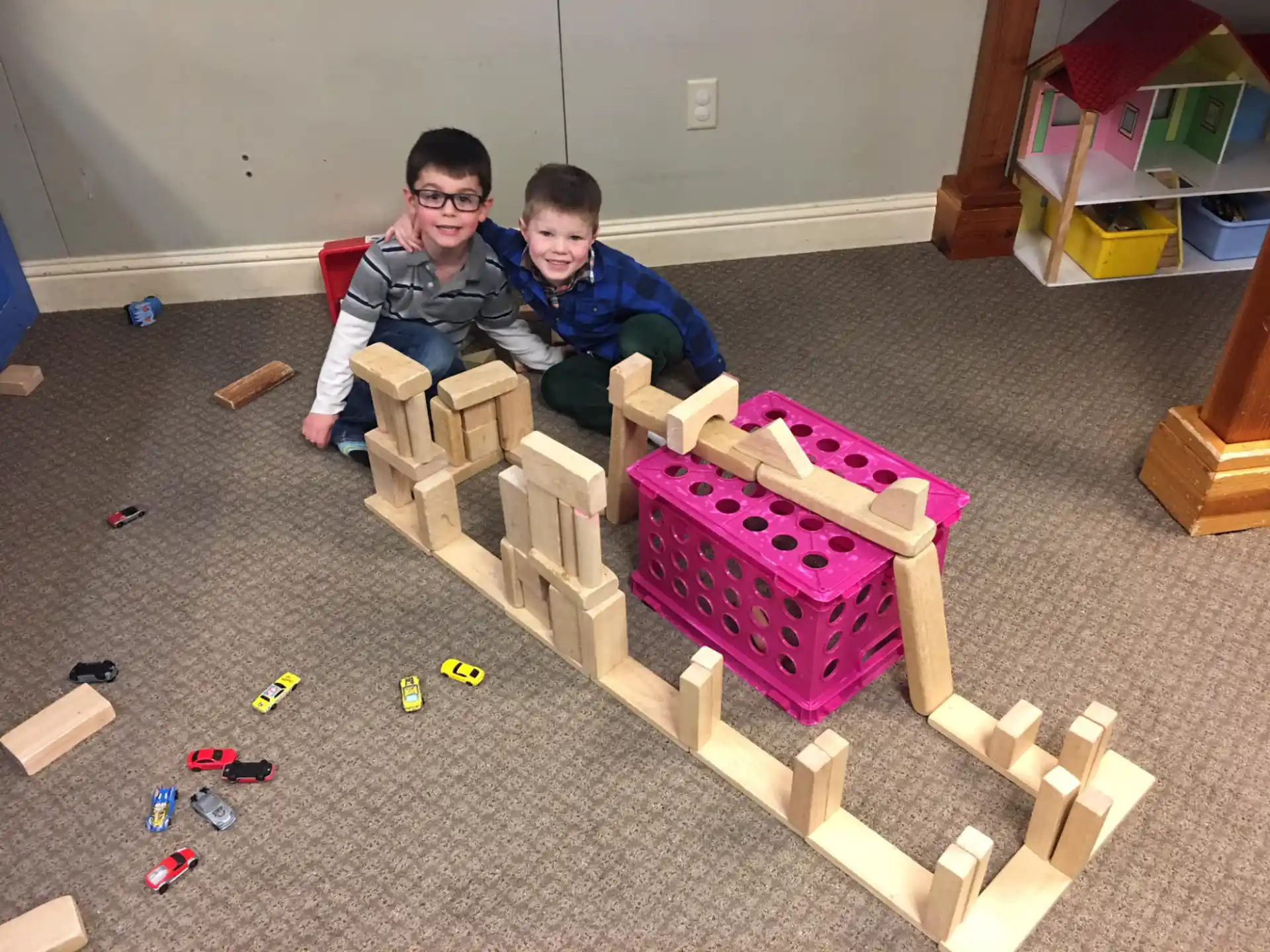 two boys sitting on a wooden structure