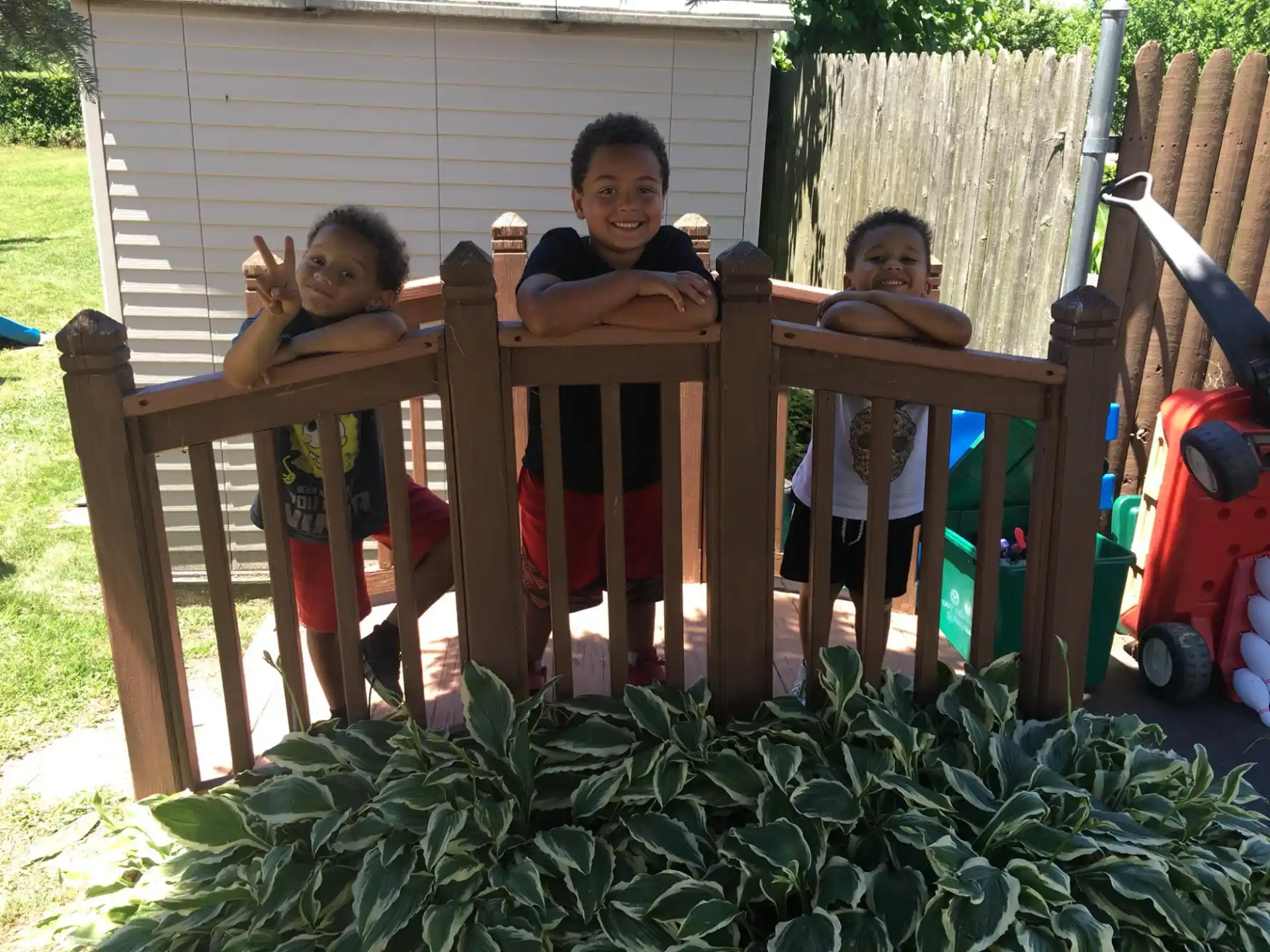 a group of children sitting on a wooden bench