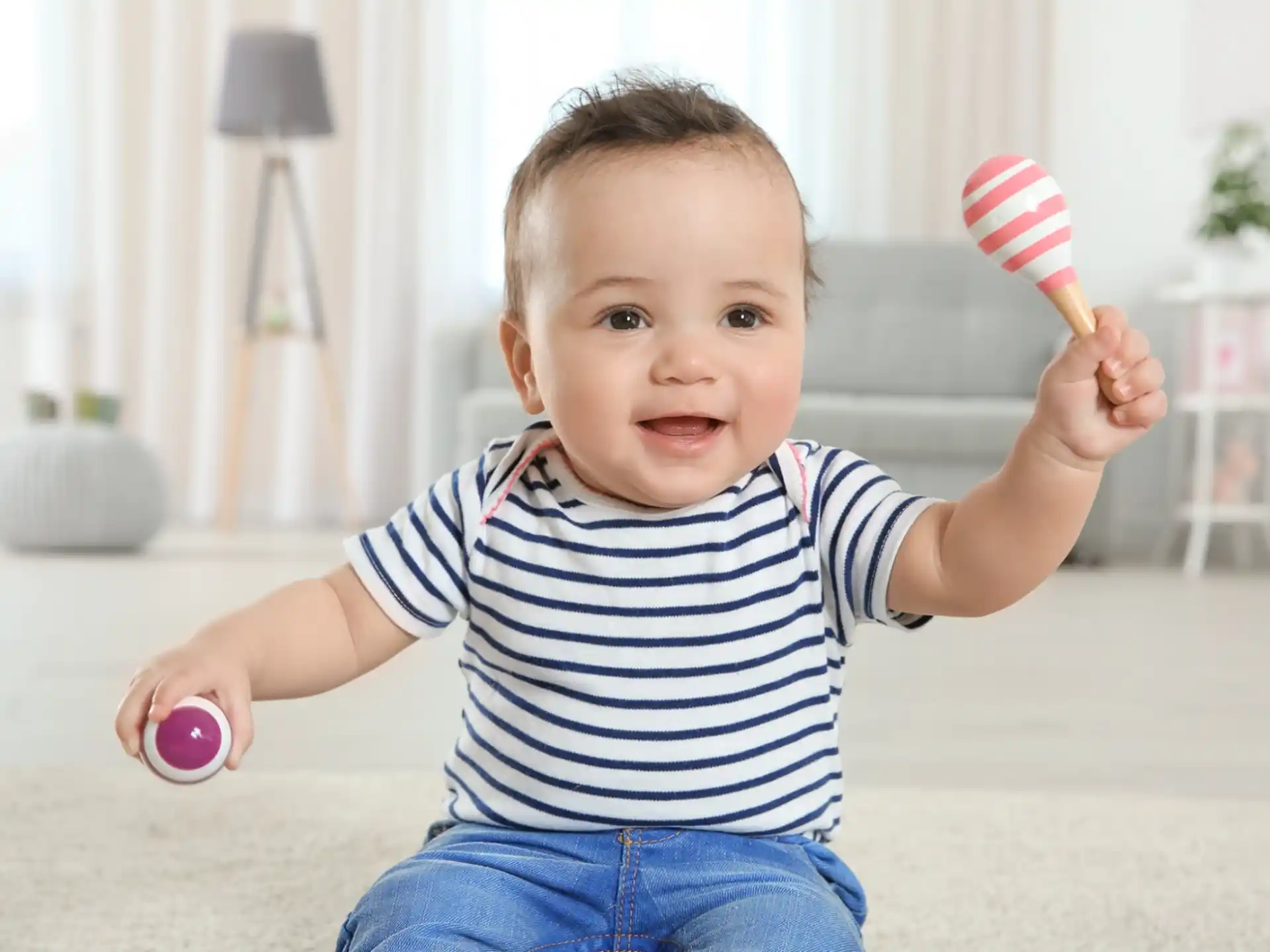 a baby holding a toy