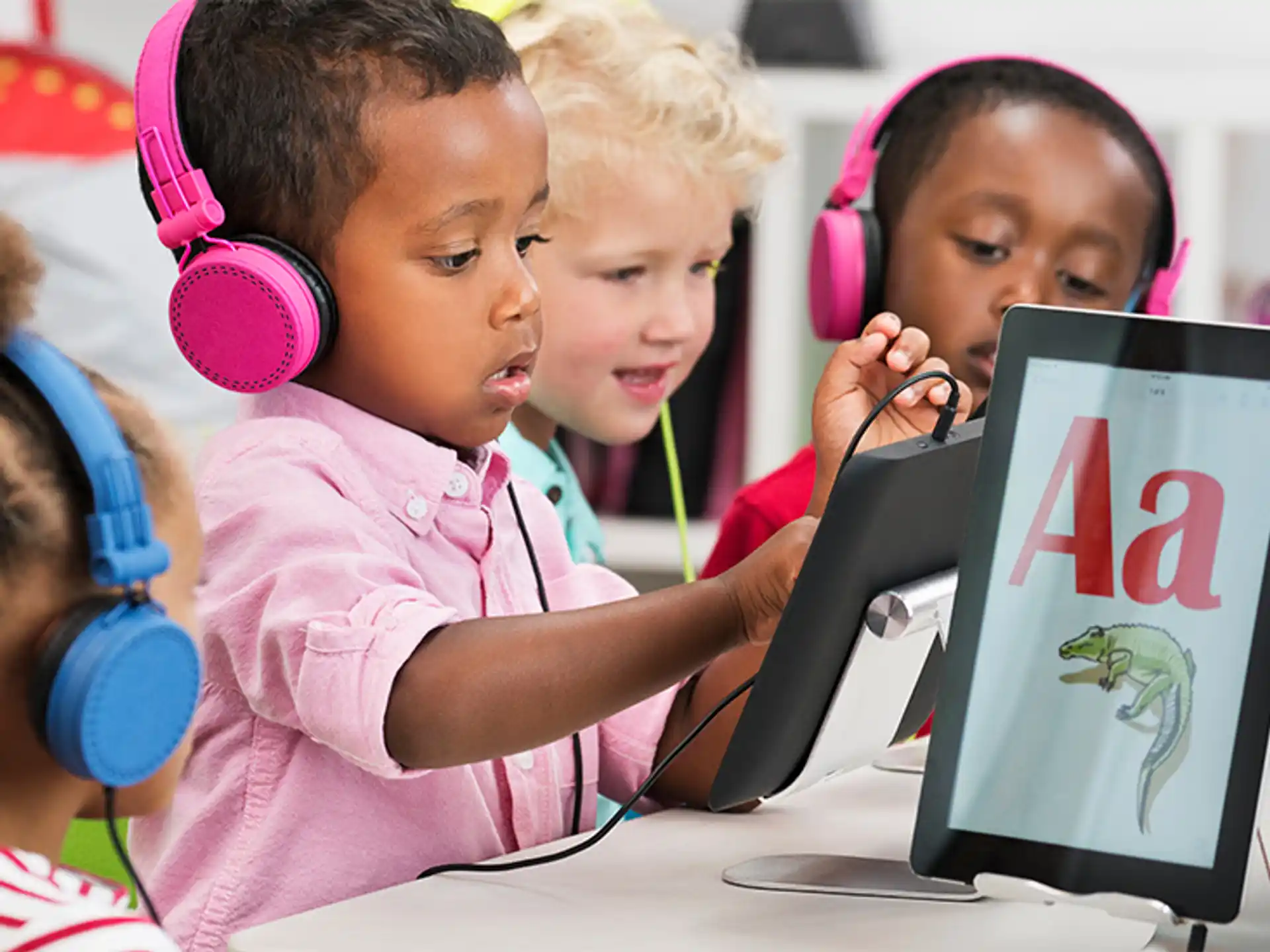 a group of children looking at a computer screen
