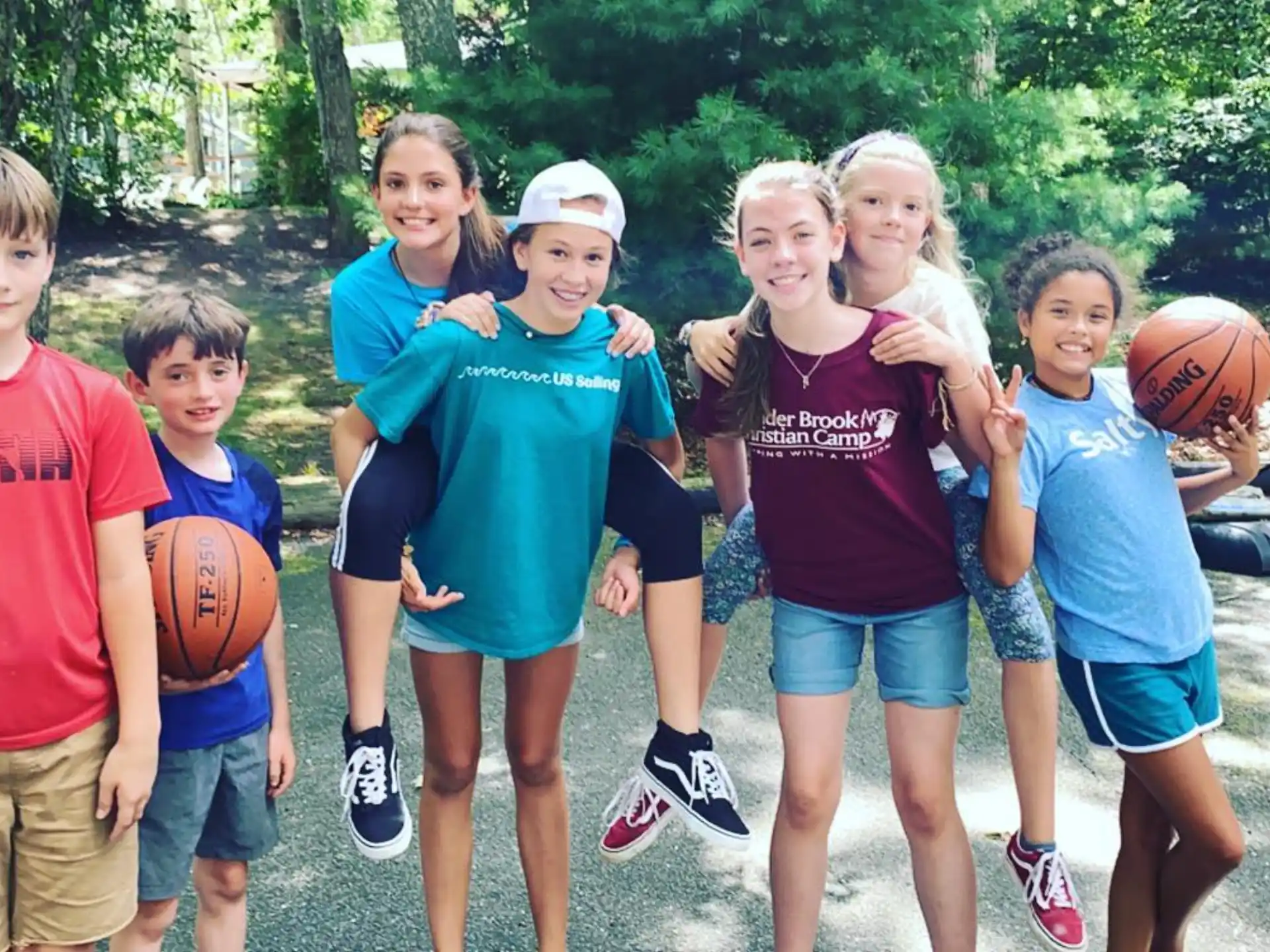 a group of kids posing for a picture with a basketball