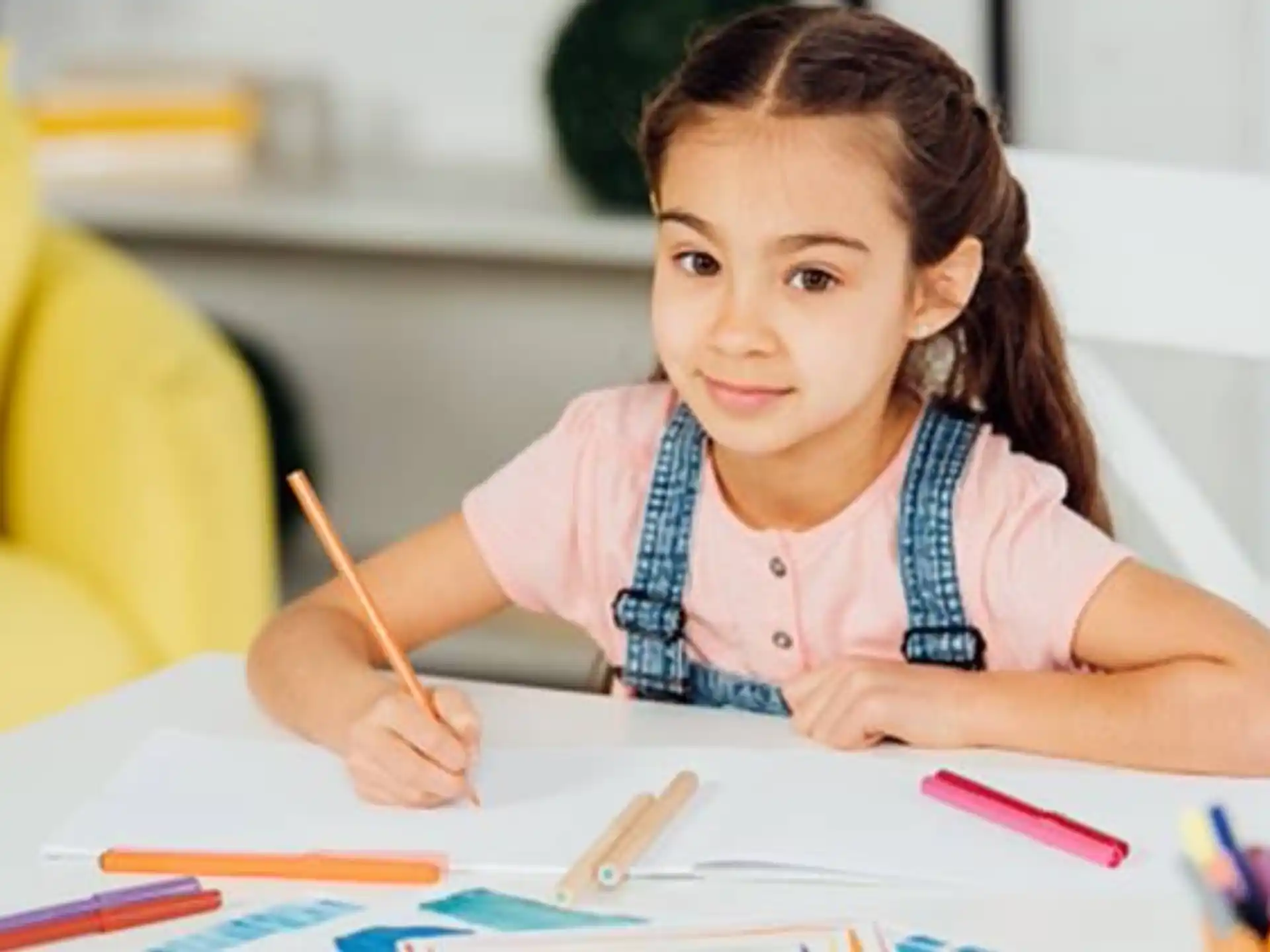 a young girl sitting at a table