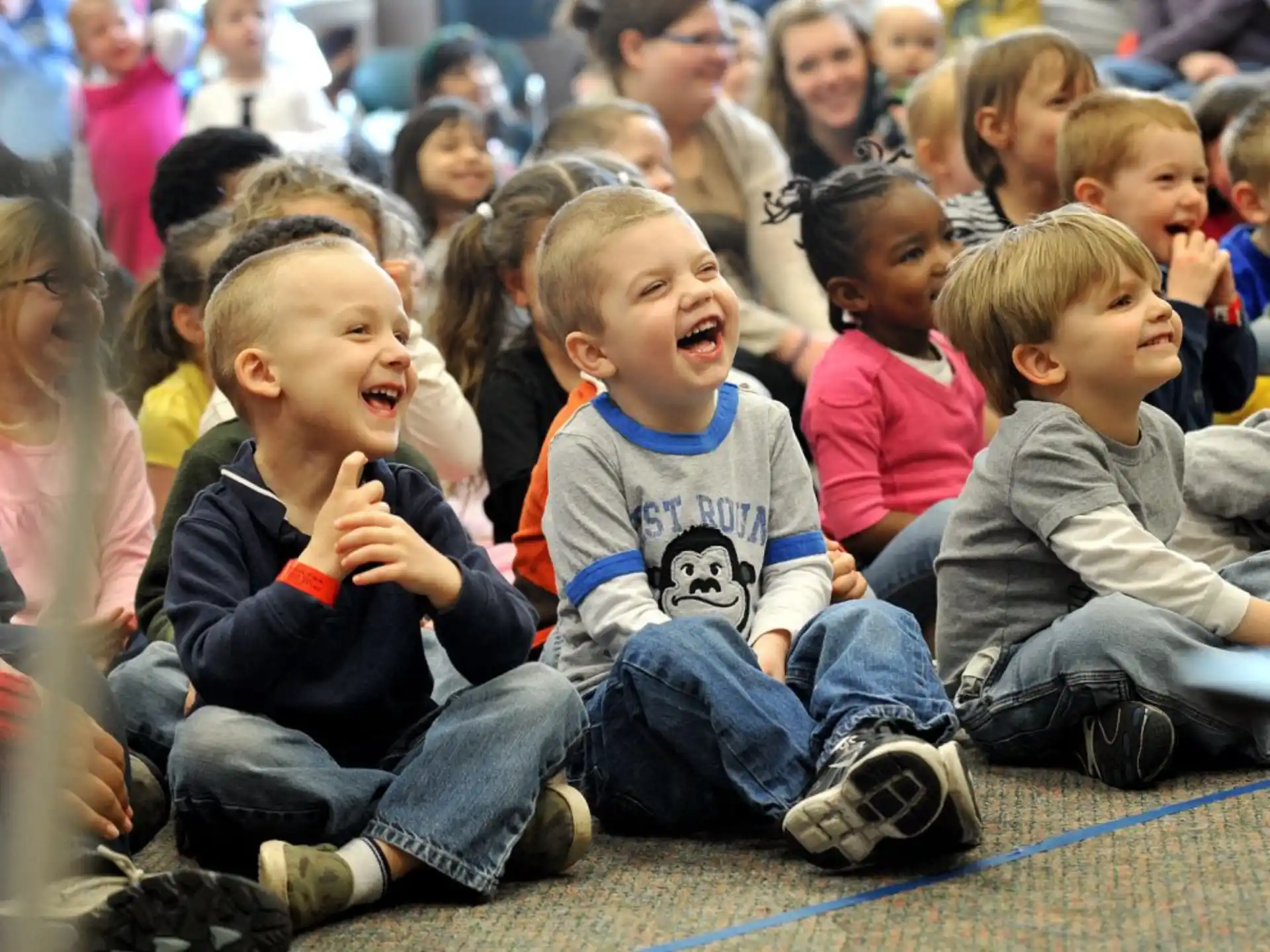 a group of children sitting on the ground