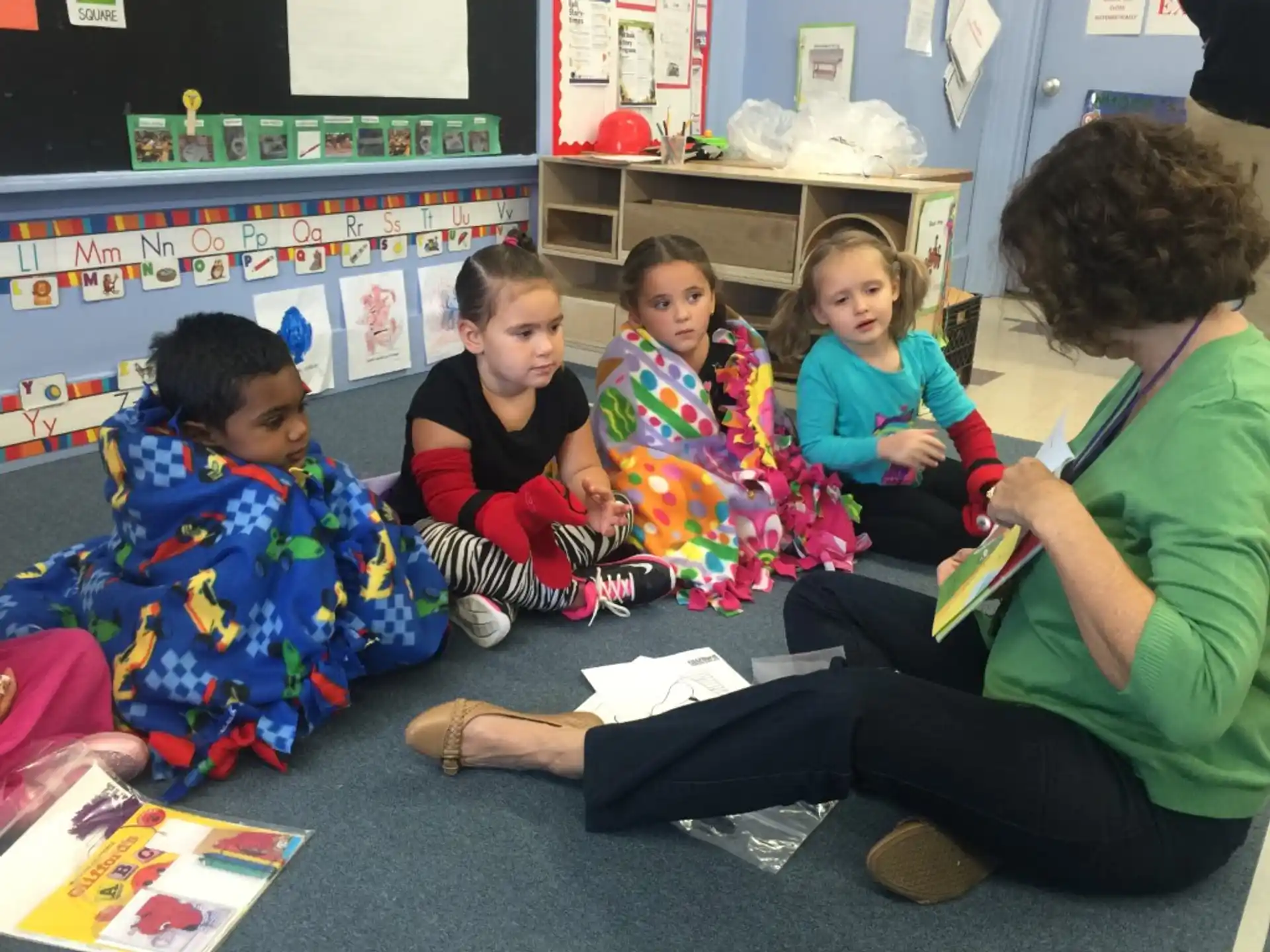 a person and several children sitting on the floor