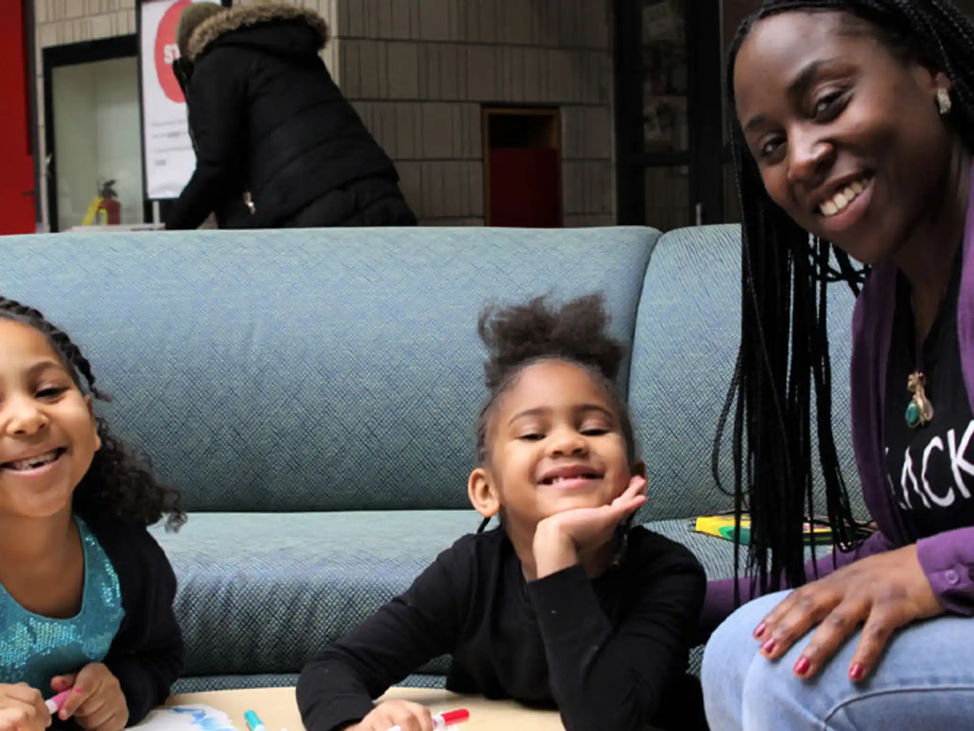a person and two children sitting on a couch