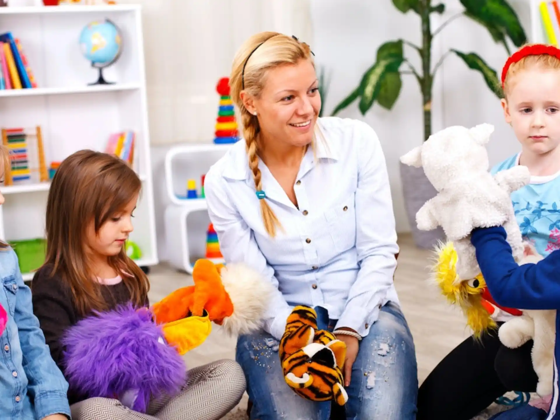 a person and children sitting on a couch with stuffed animals