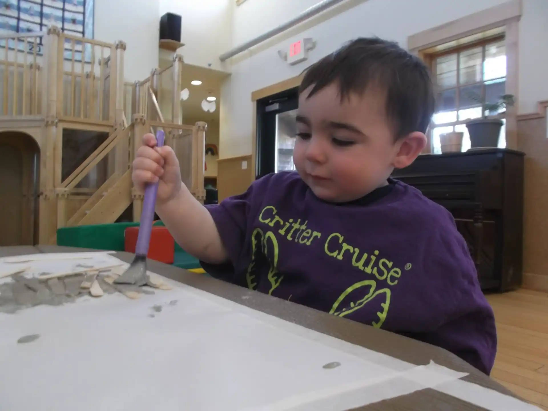 a boy painting on a table