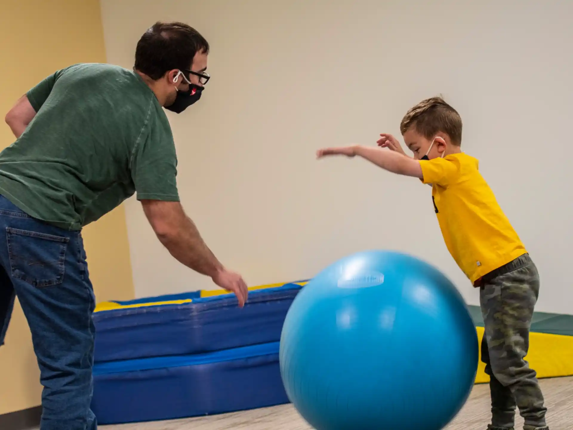 a man and a boy playing with a ball