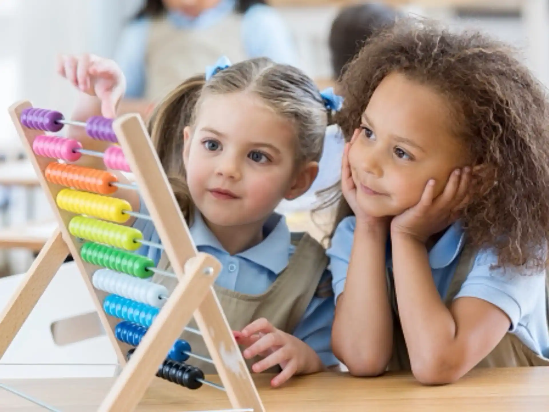 a couple of children looking at a toy