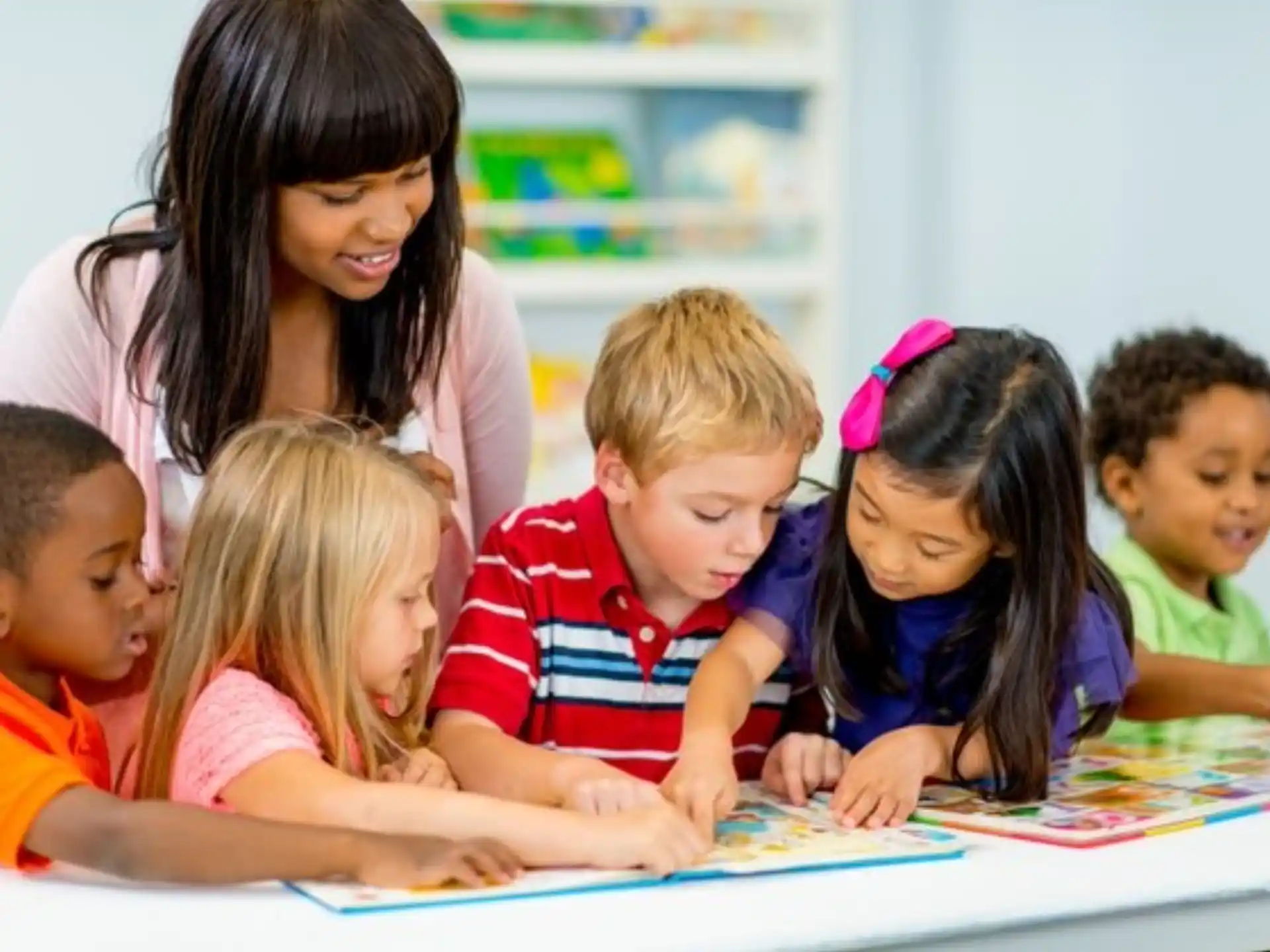 a group of children looking at a paper