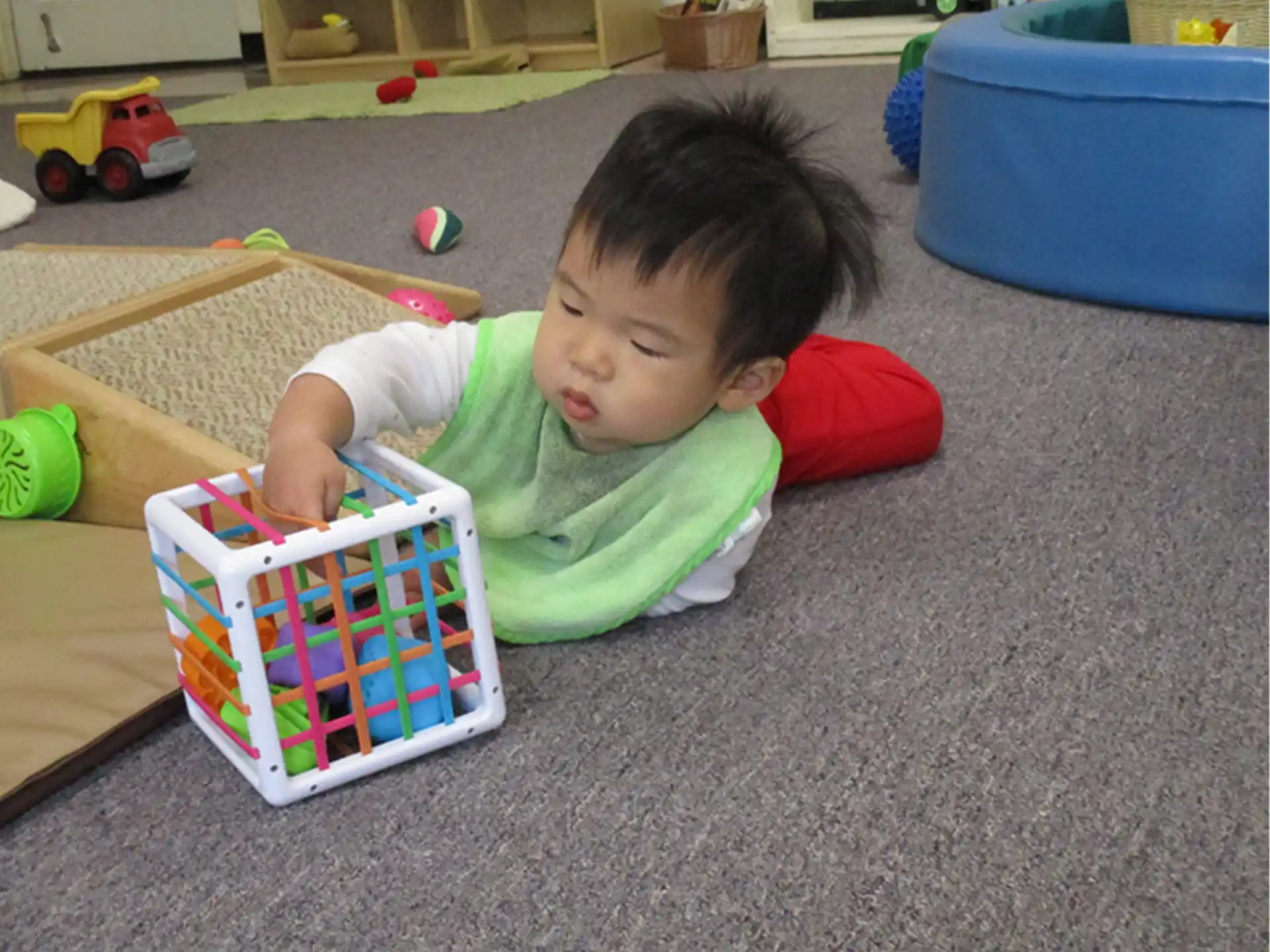 a baby lying on the floor