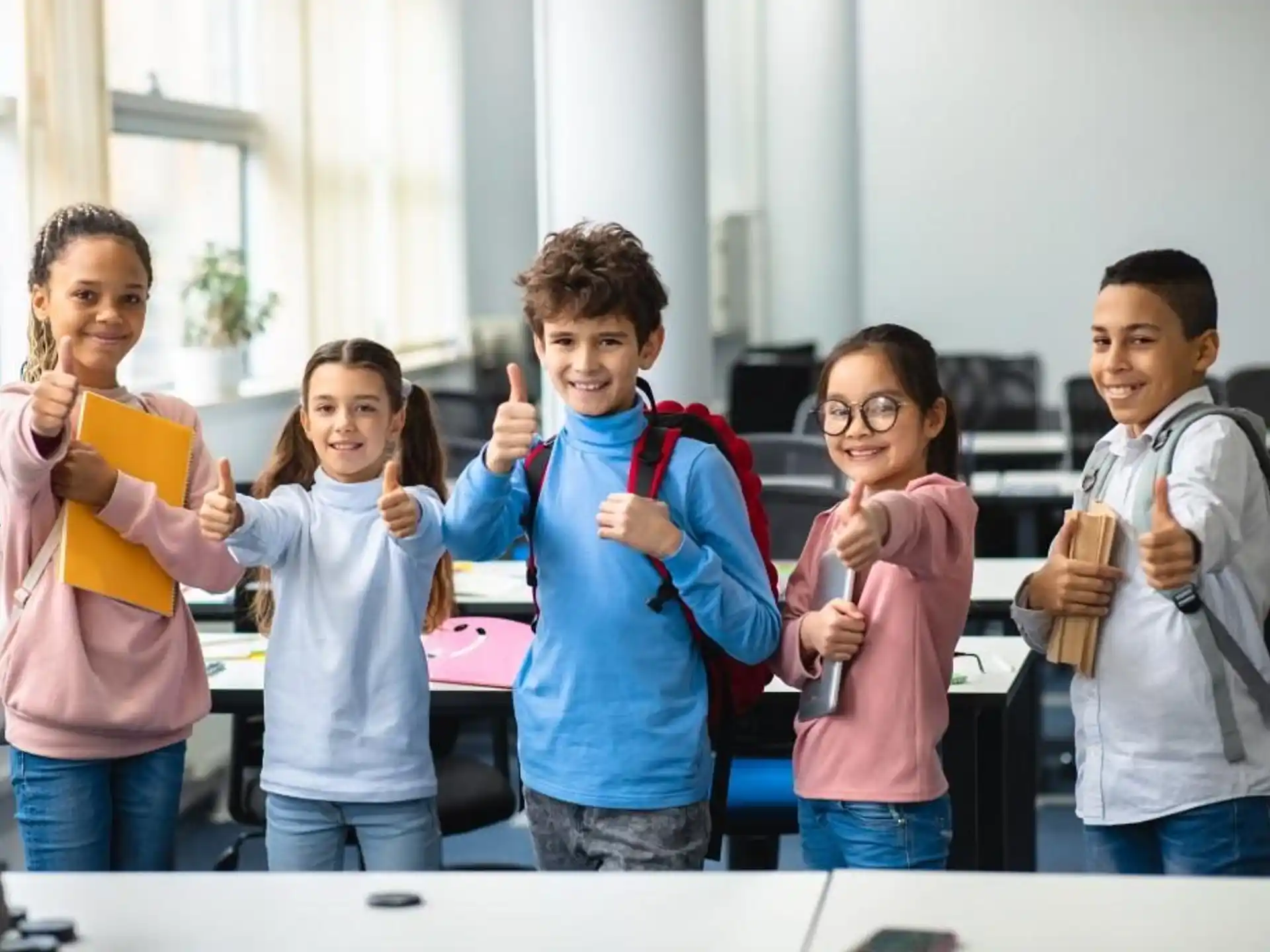 a group of kids holding their hands up