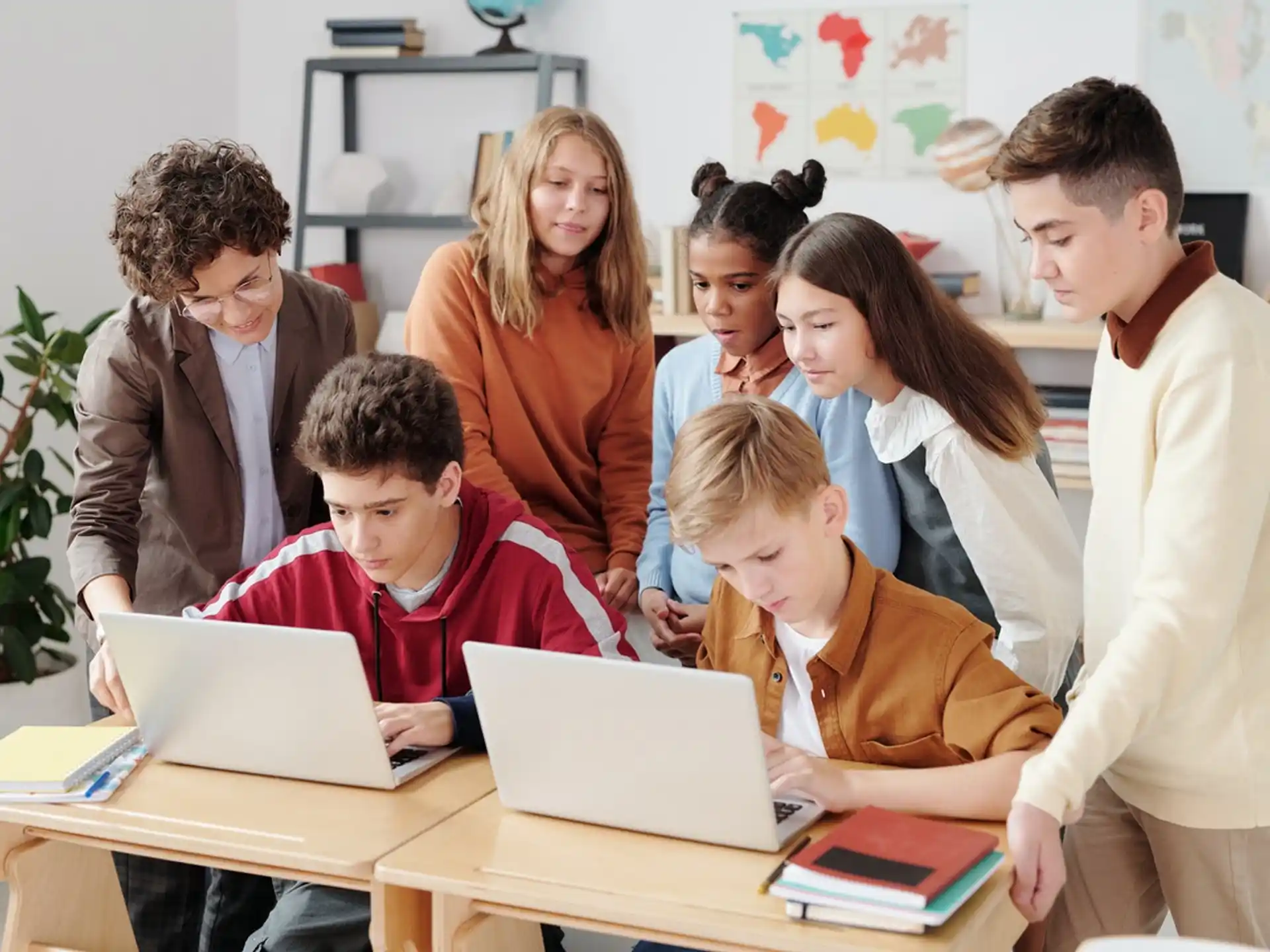 a group of people looking at a laptop