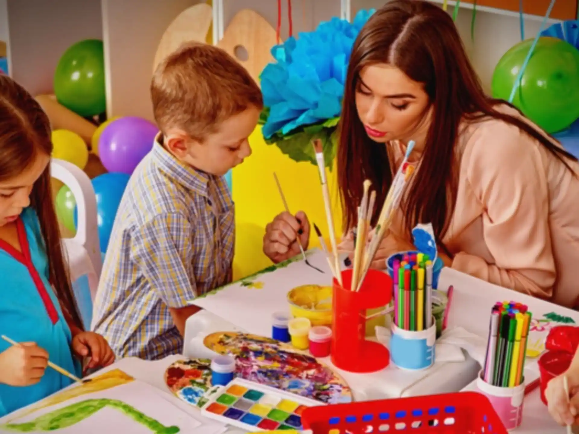 a person and two children painting