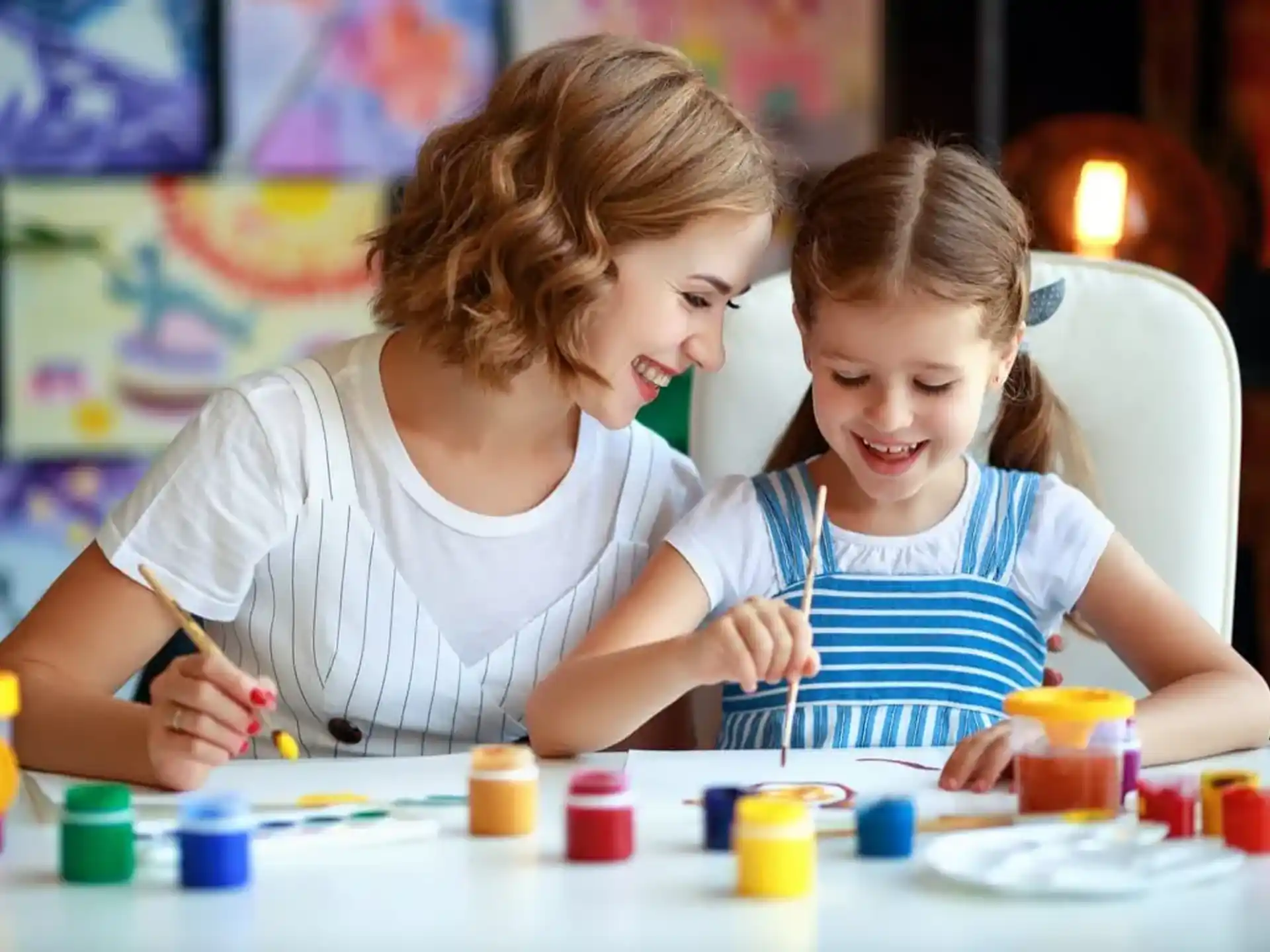 a person and a child painting