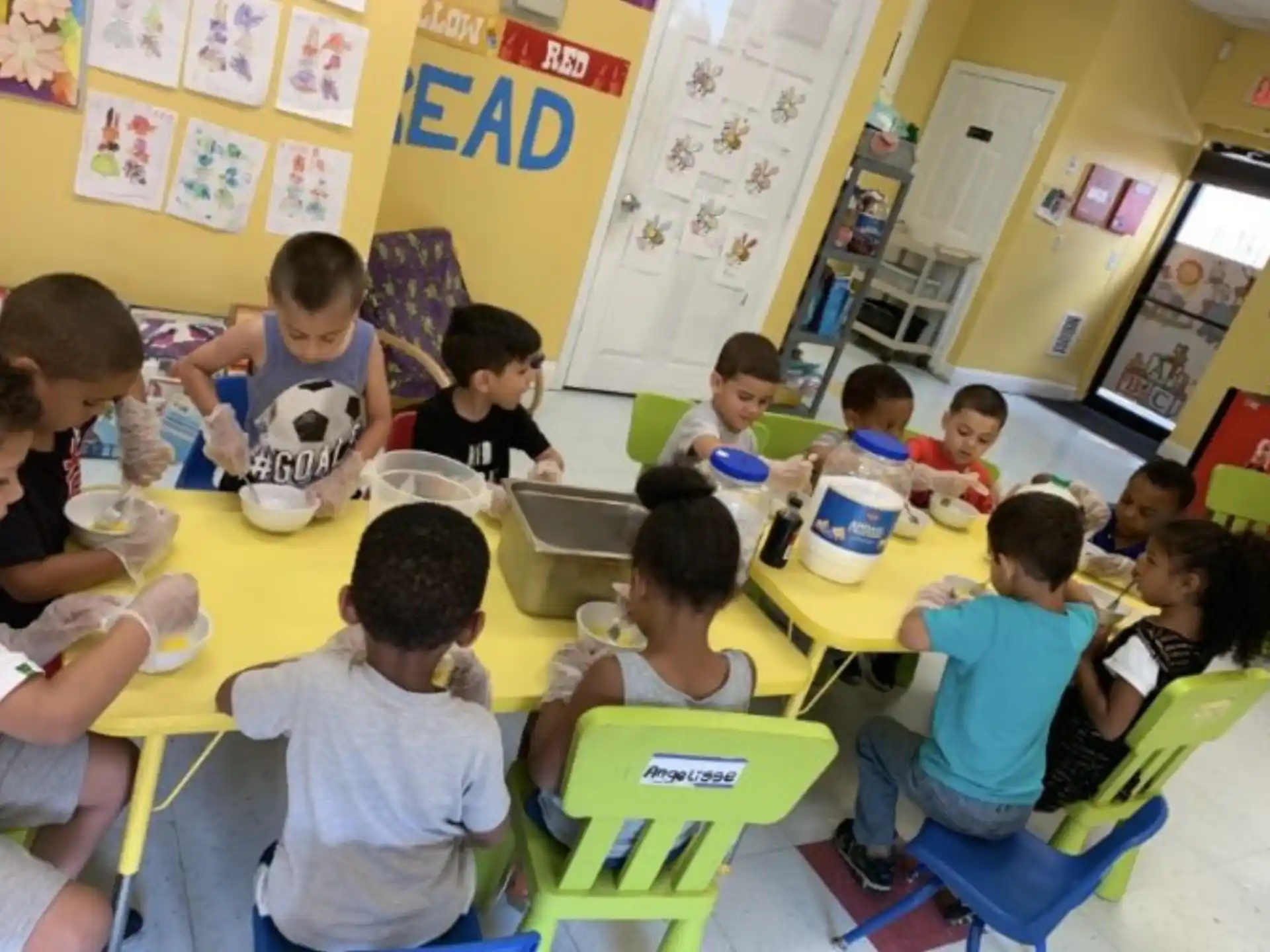 a group of children eating at a table