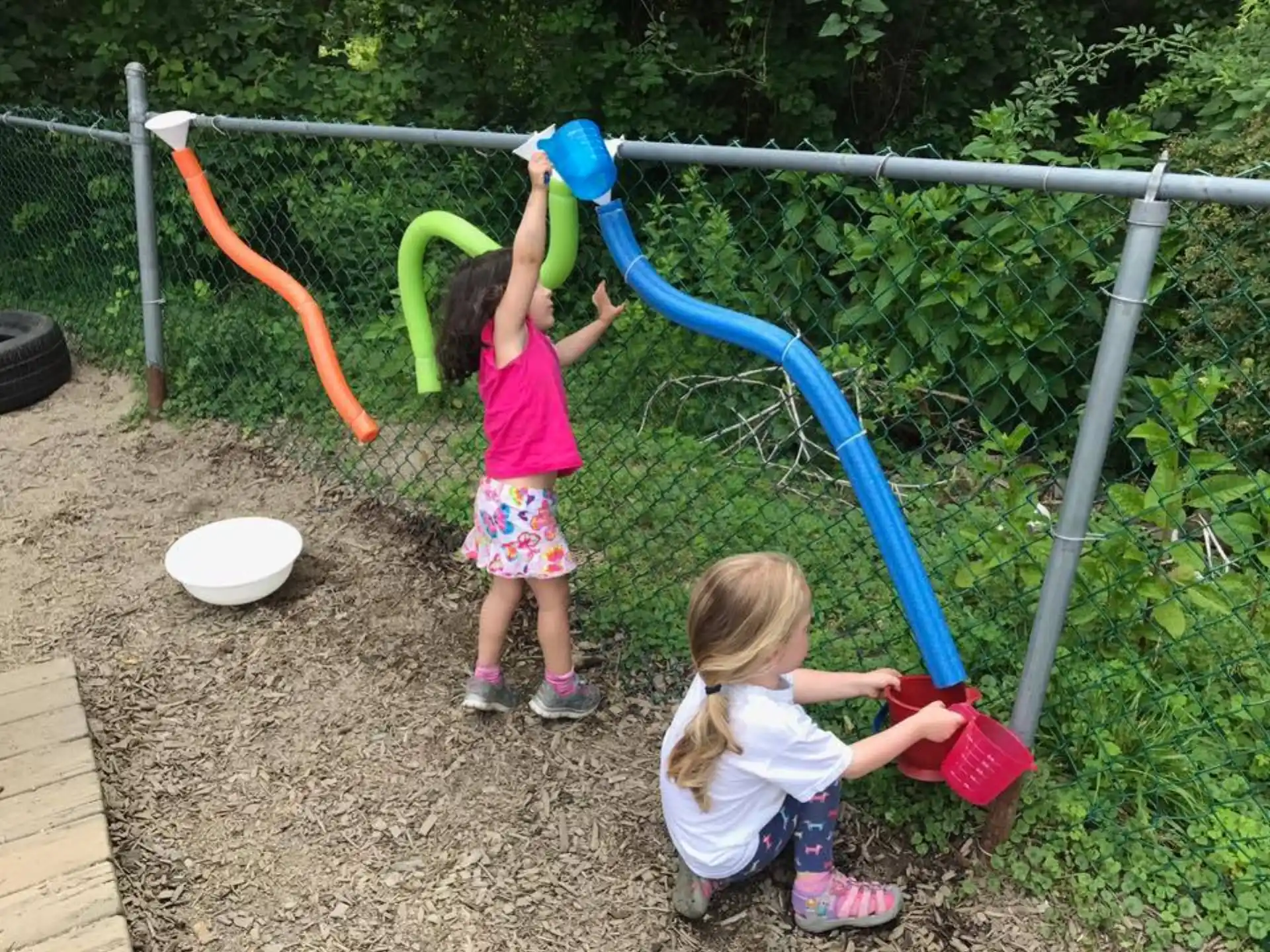 two girls playing with a toy