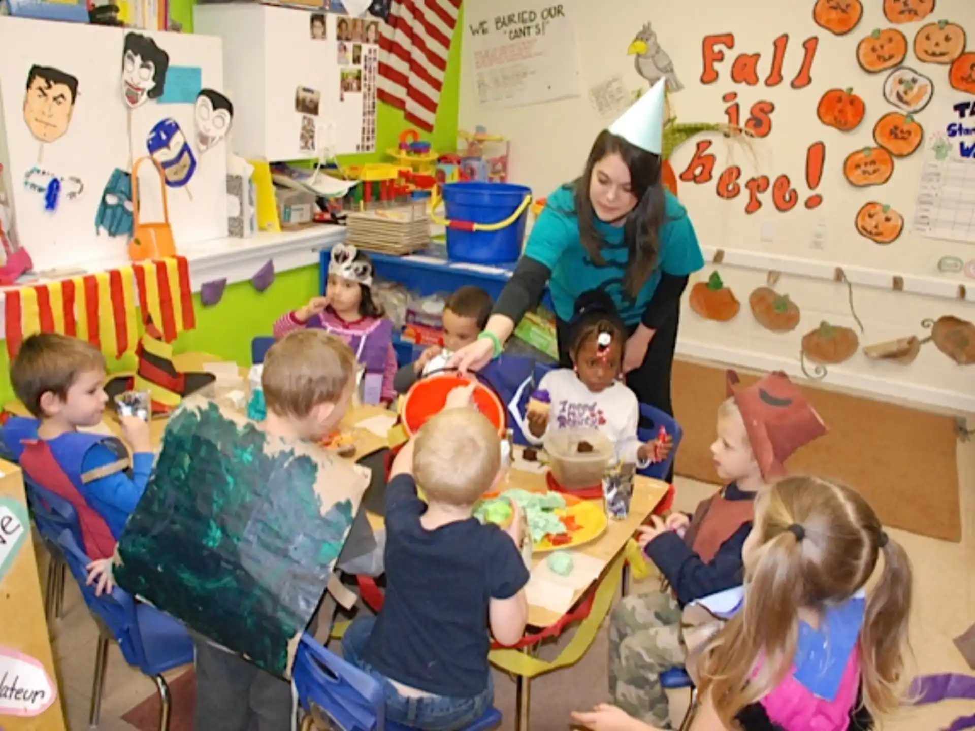a person and several children in a classroom