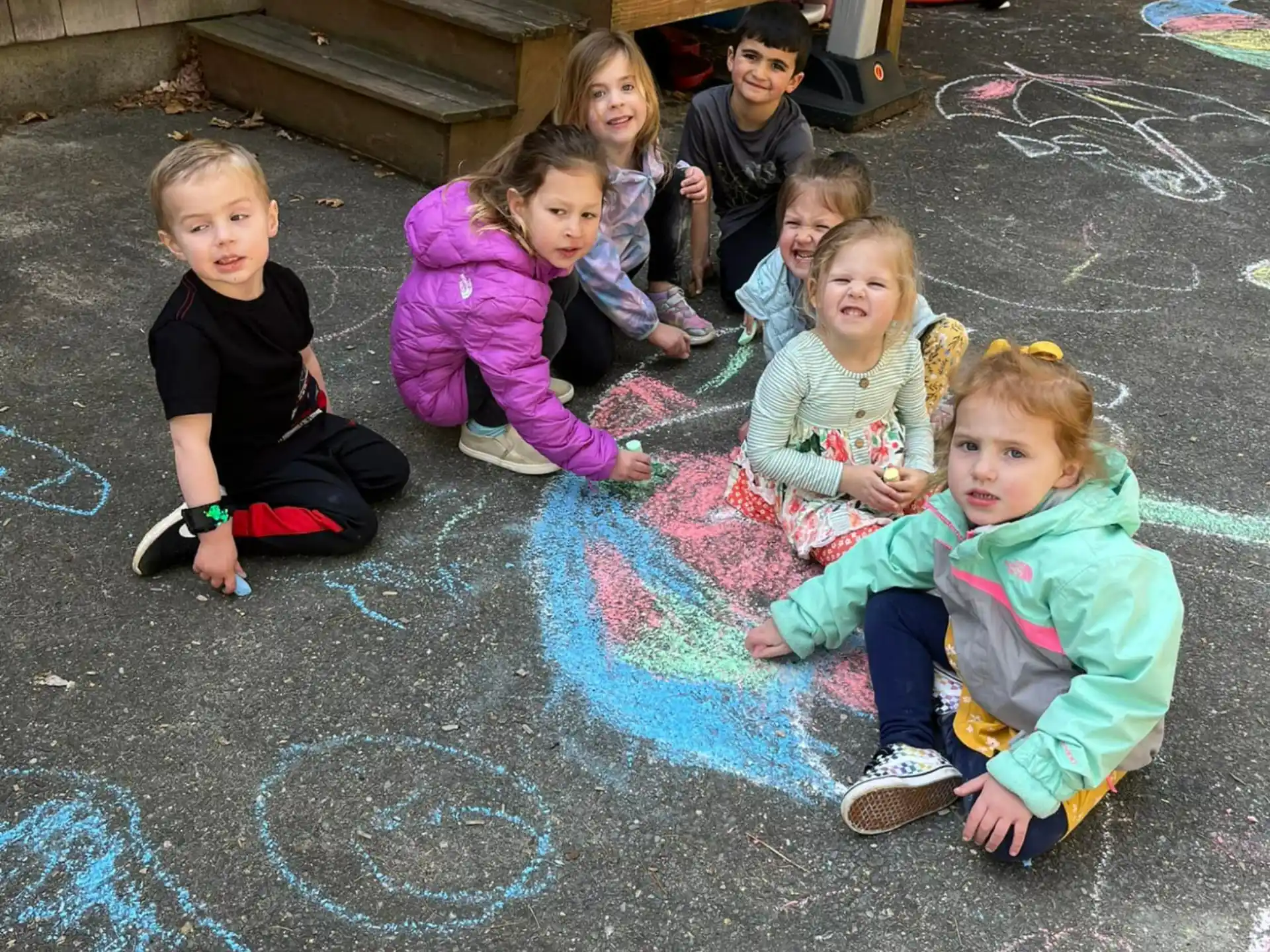 a group of children sitting on the ground