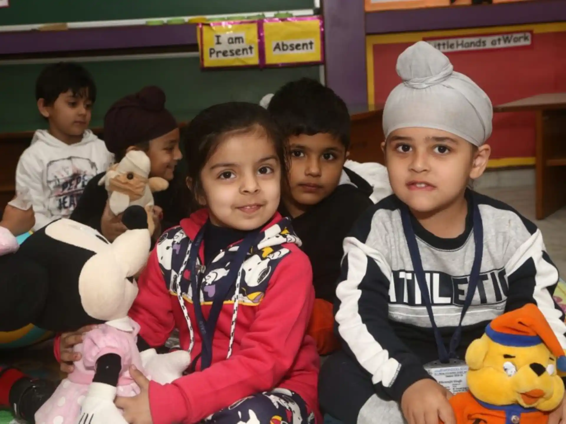 a group of children holding stuffed animals