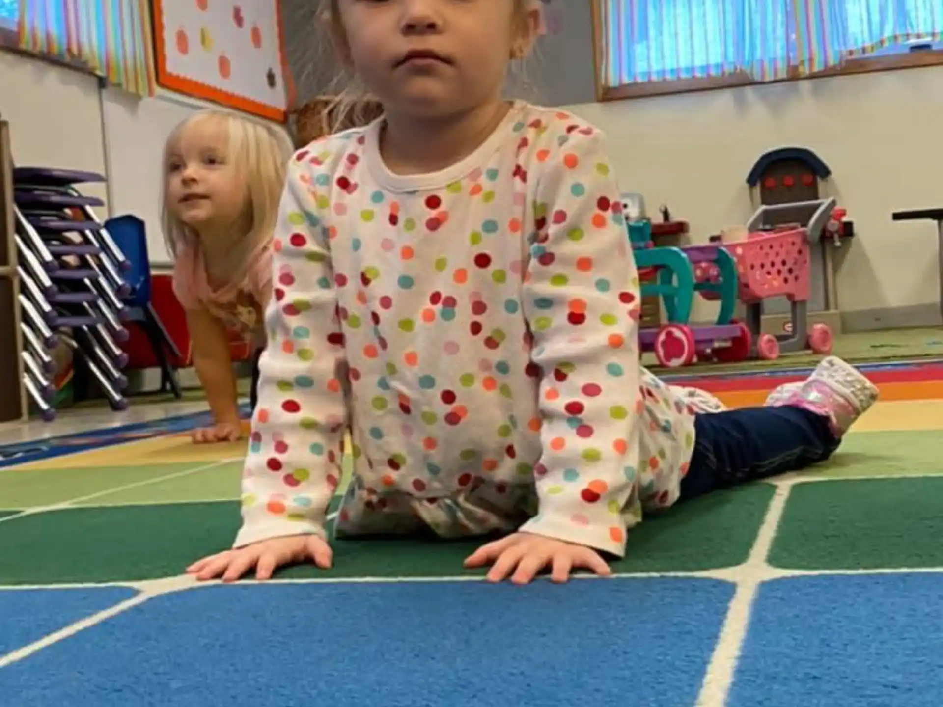 a young girl sitting on the floor
