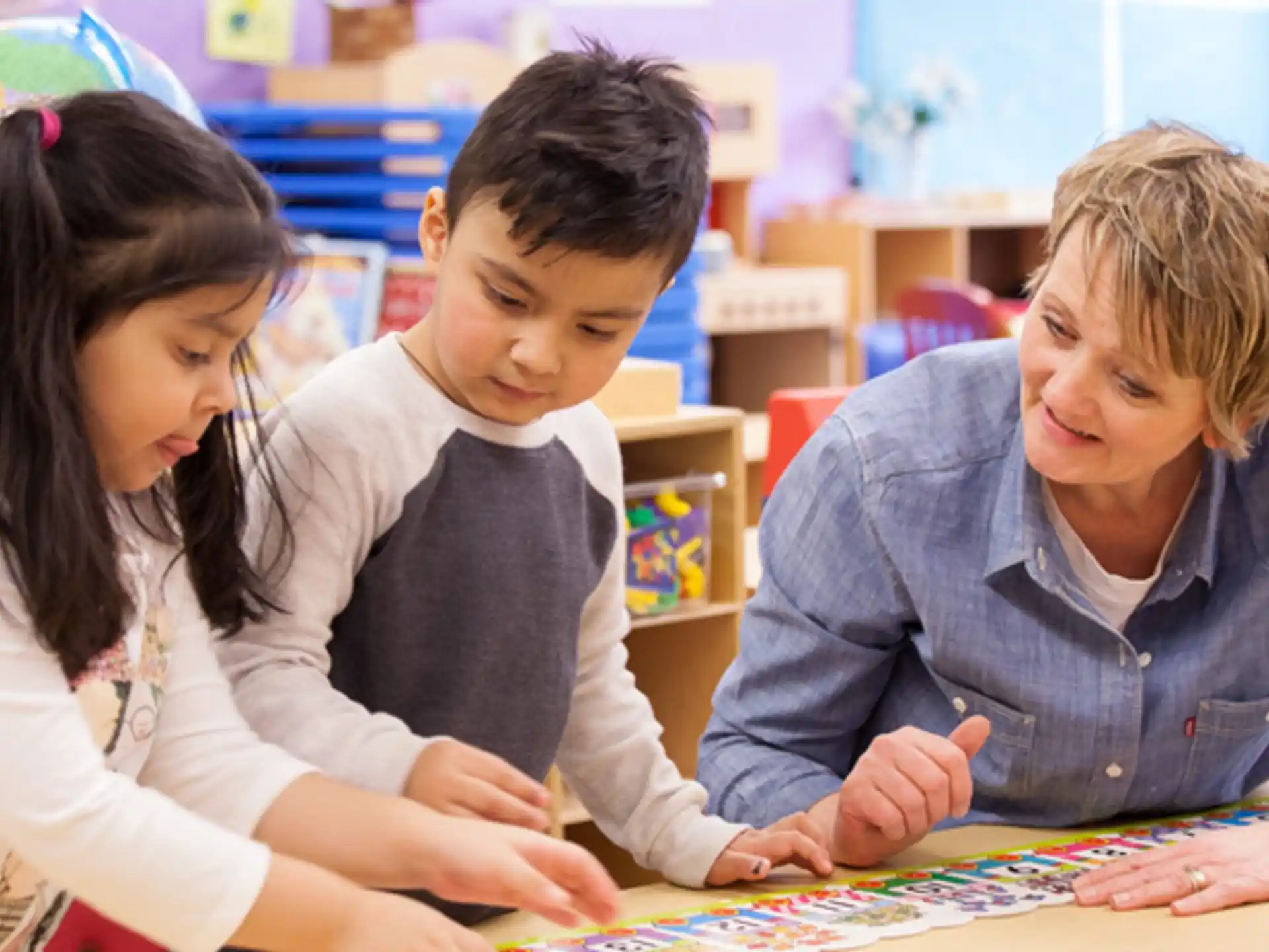 a group of children looking at a map