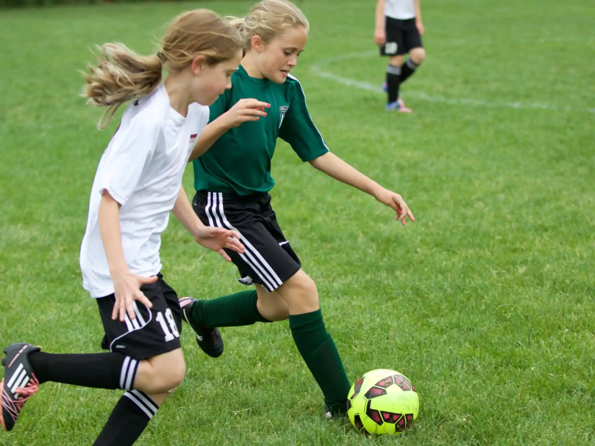 girls playing football on a field