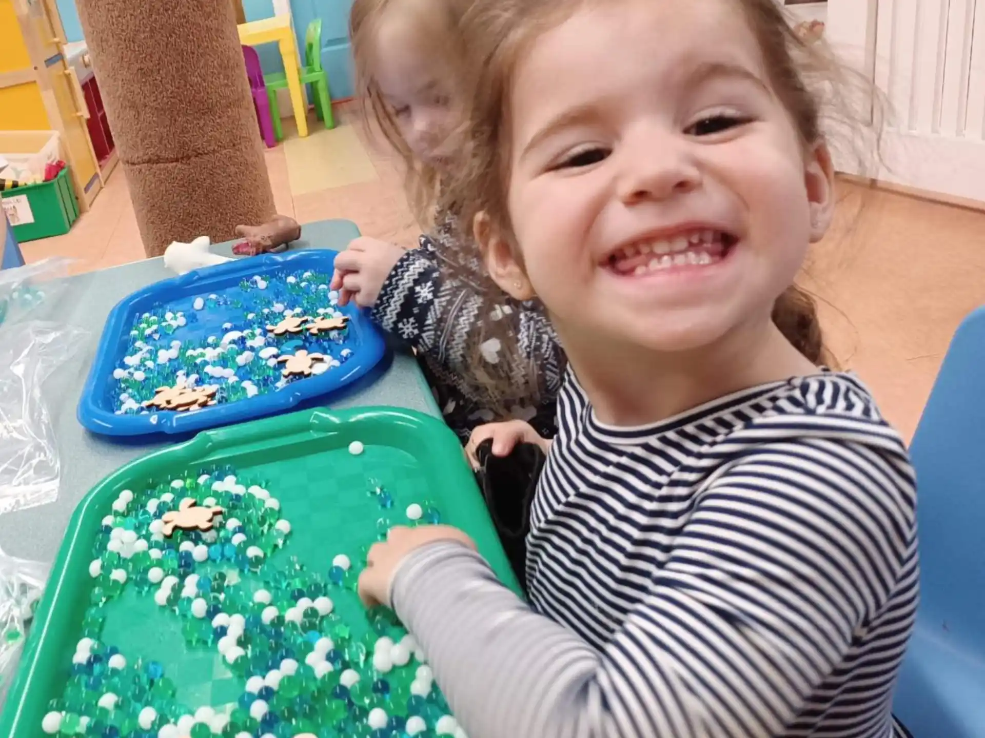 a couple of girls smiling at the camera