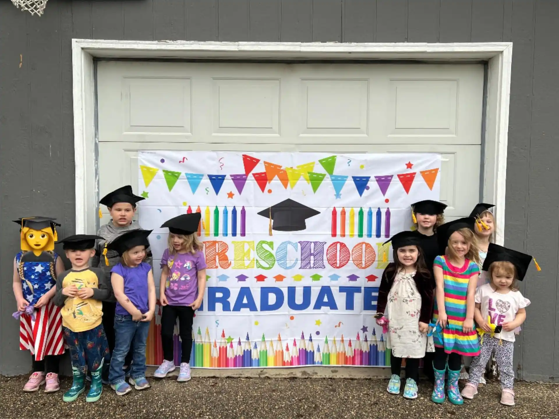 a group of children posing for a photo in front of a sign