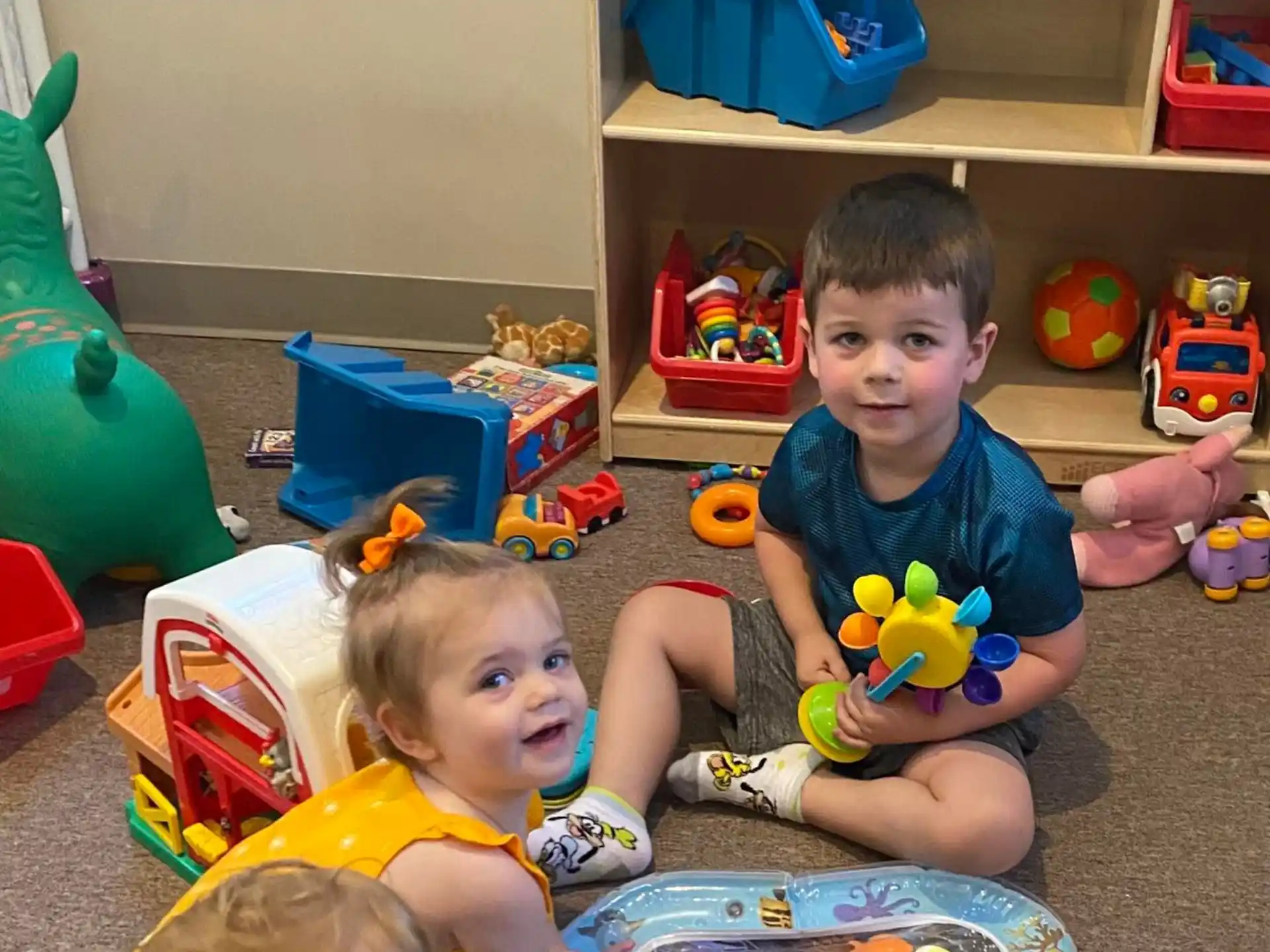 a couple of kids playing with toys