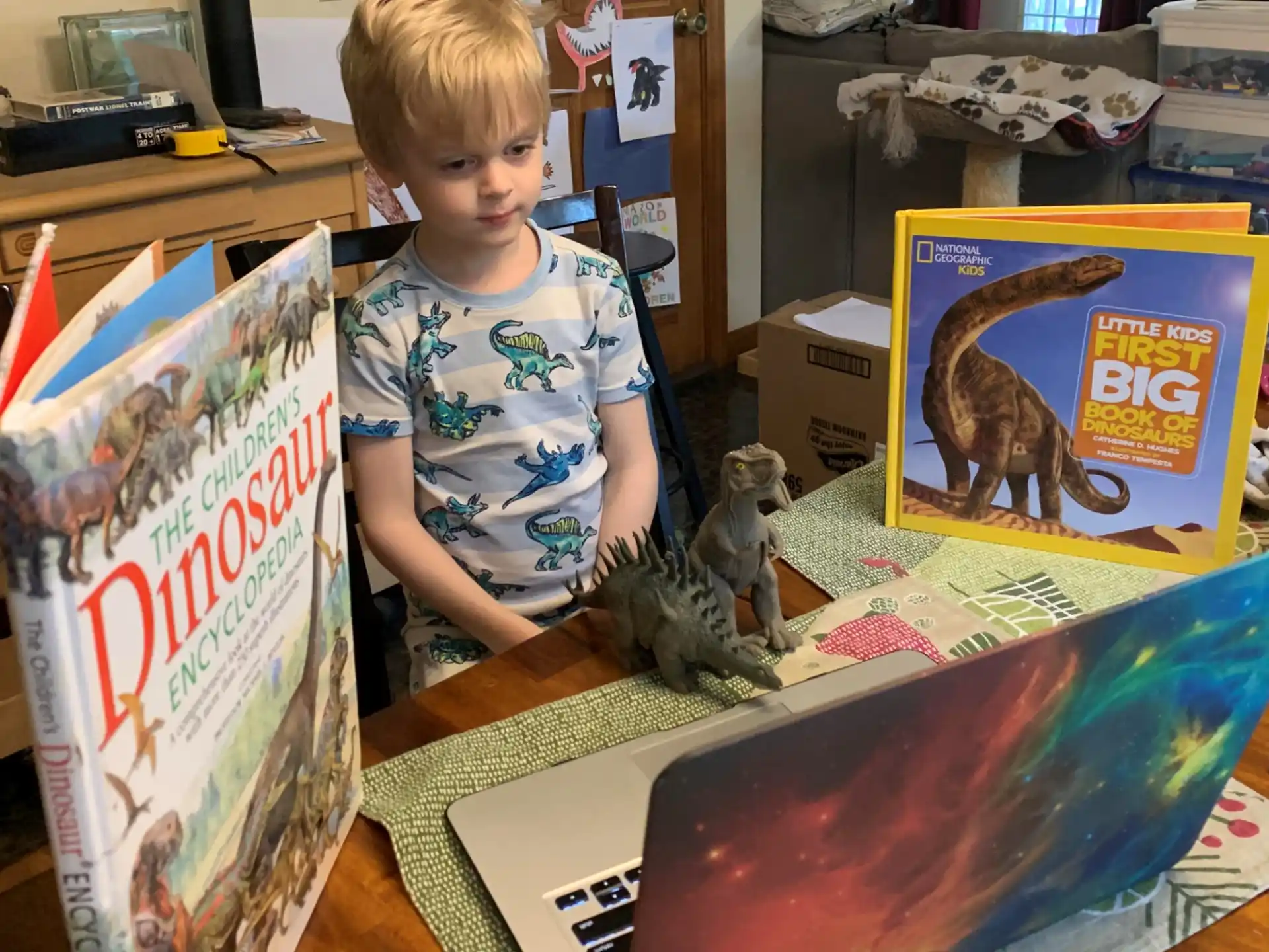 a child standing next to a table with toys on it