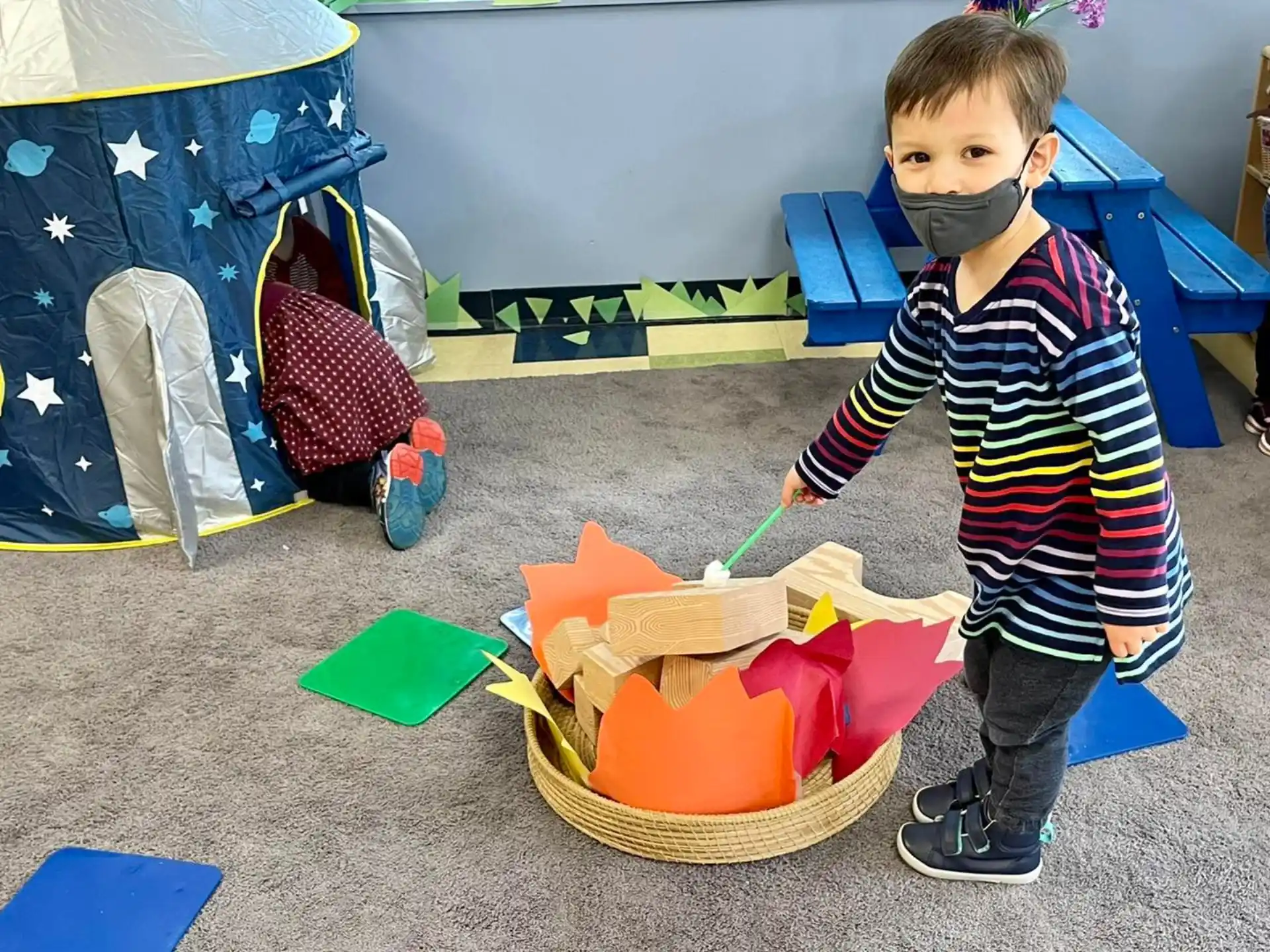 a boy holding a toy