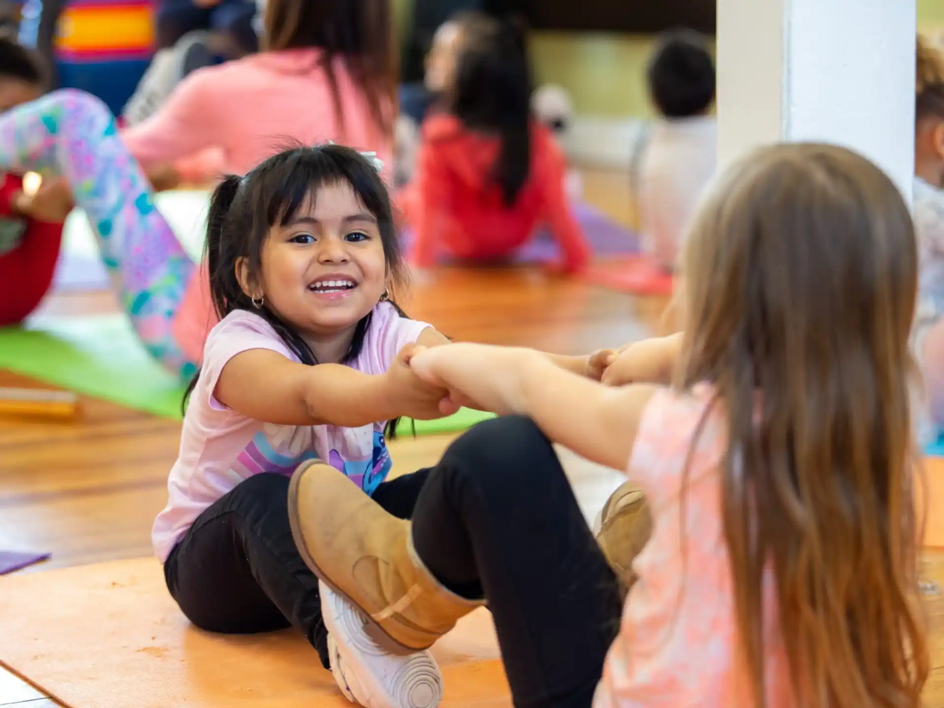 a young girl sitting on the floor
