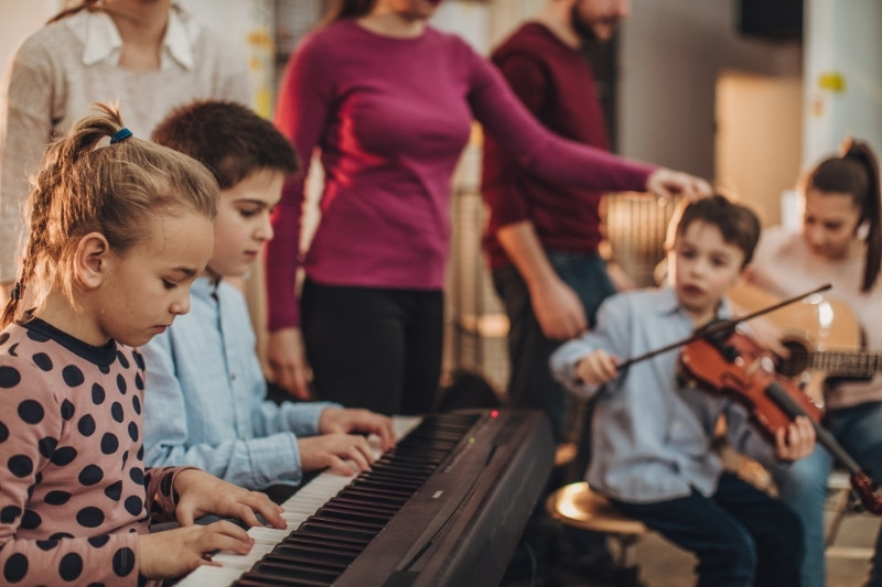 a group of children playing musical instruments