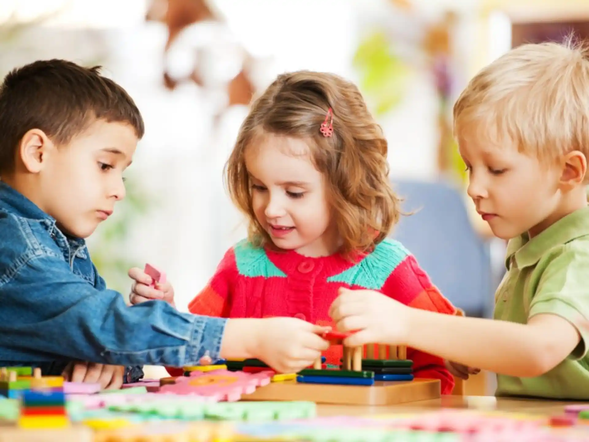 a group of children looking at a book