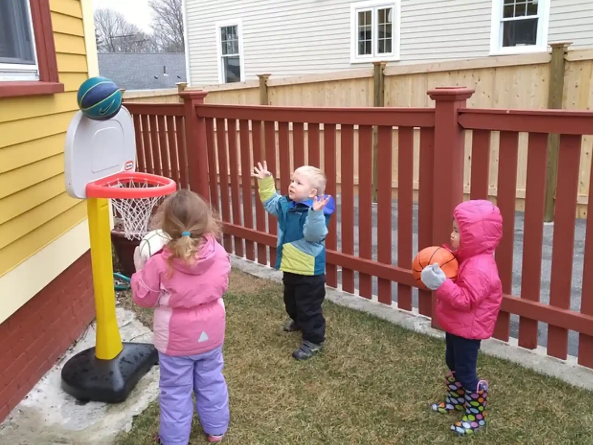 a group of children playing in a yard