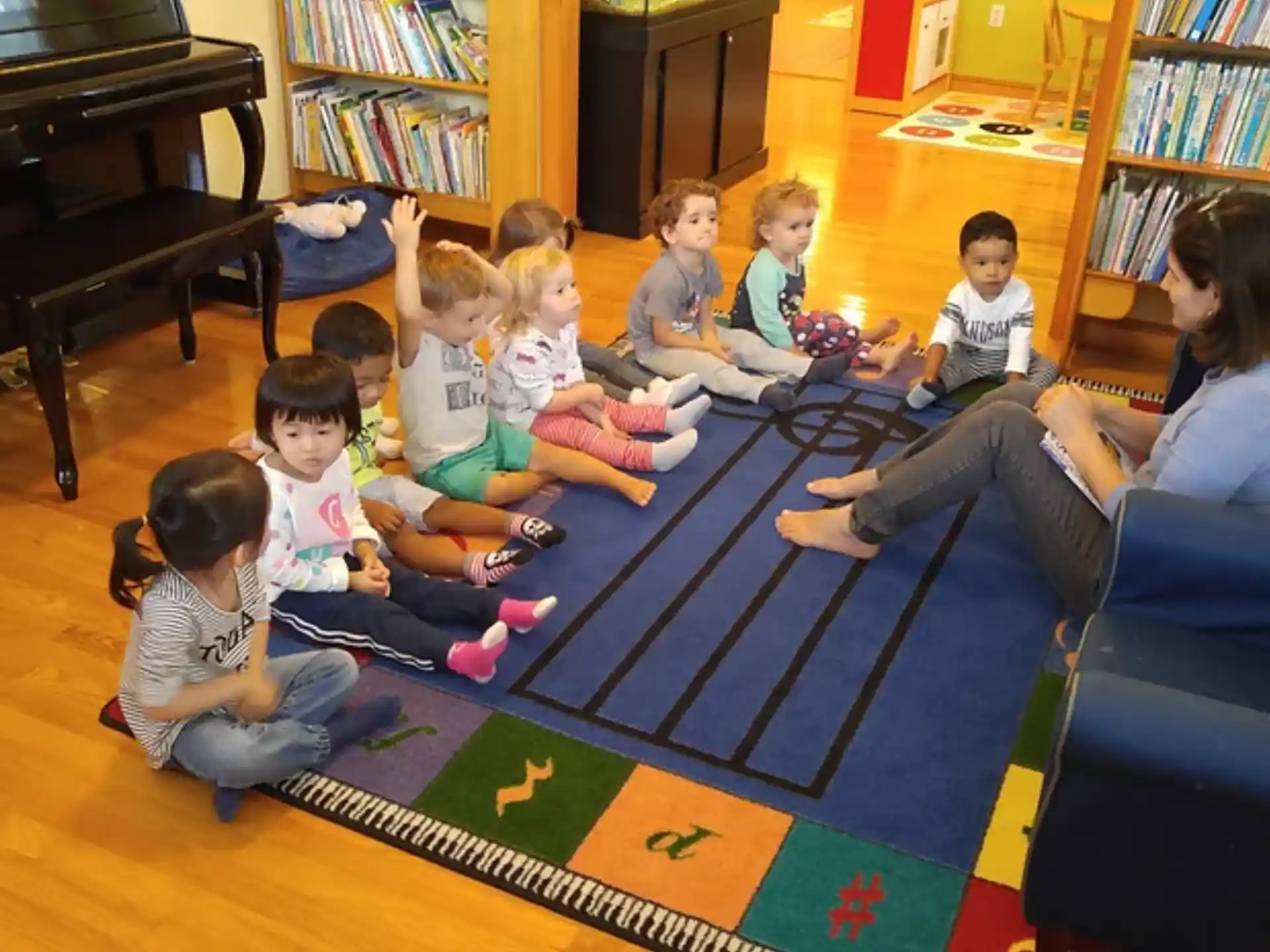 a group of children sitting on the floor in a room