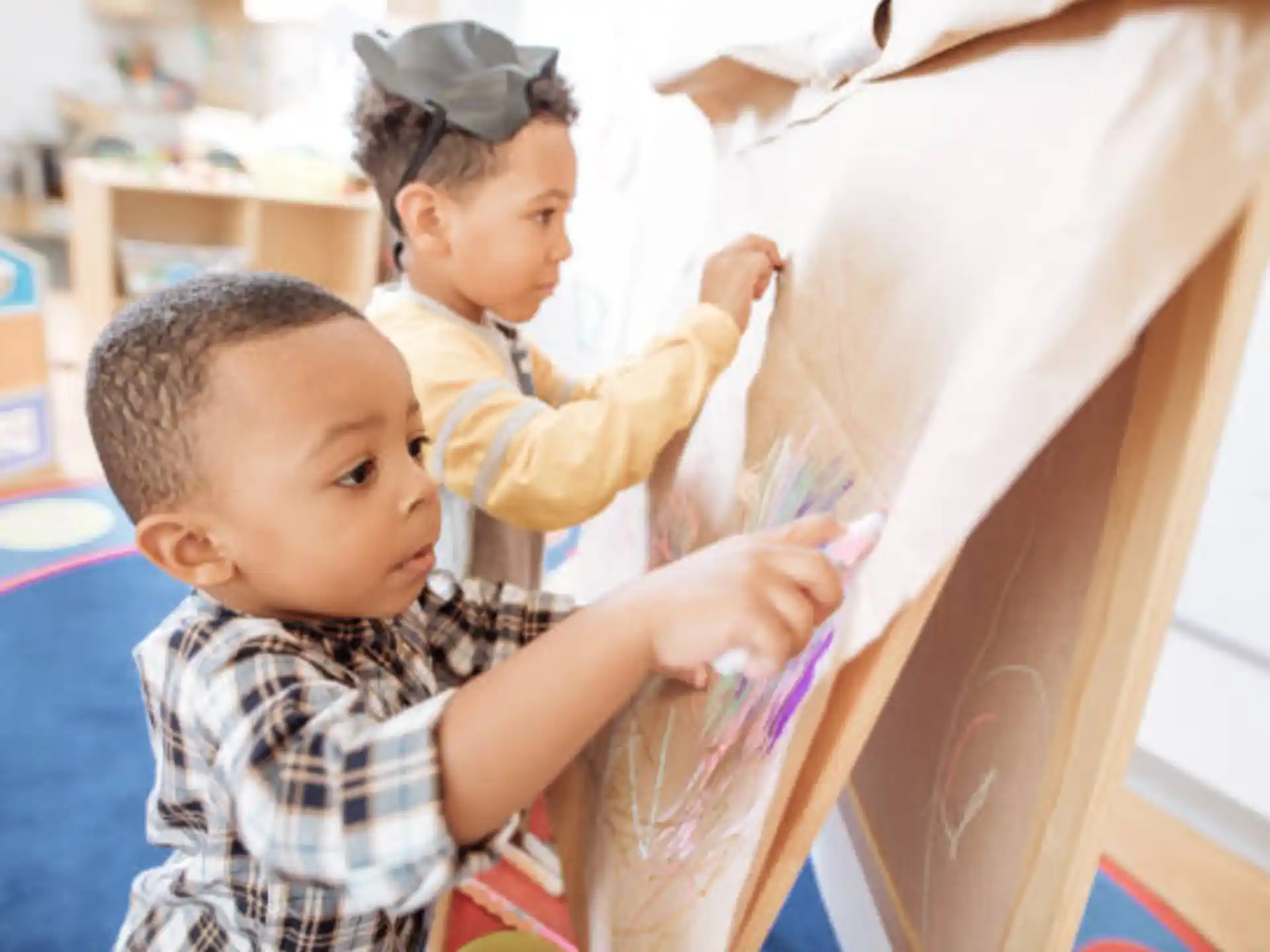 a couple of young children playing with a toy