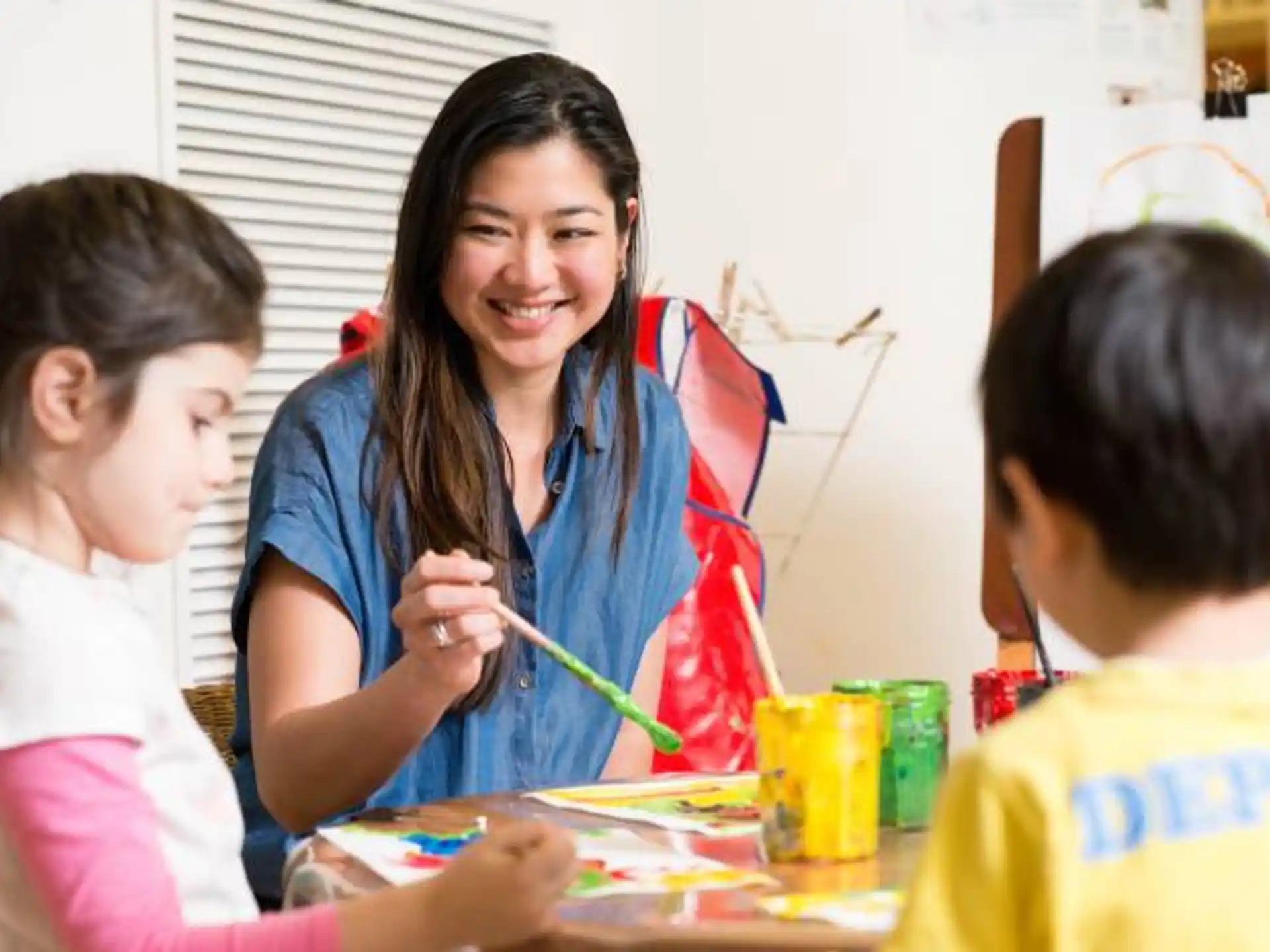 a person and children sitting at a table