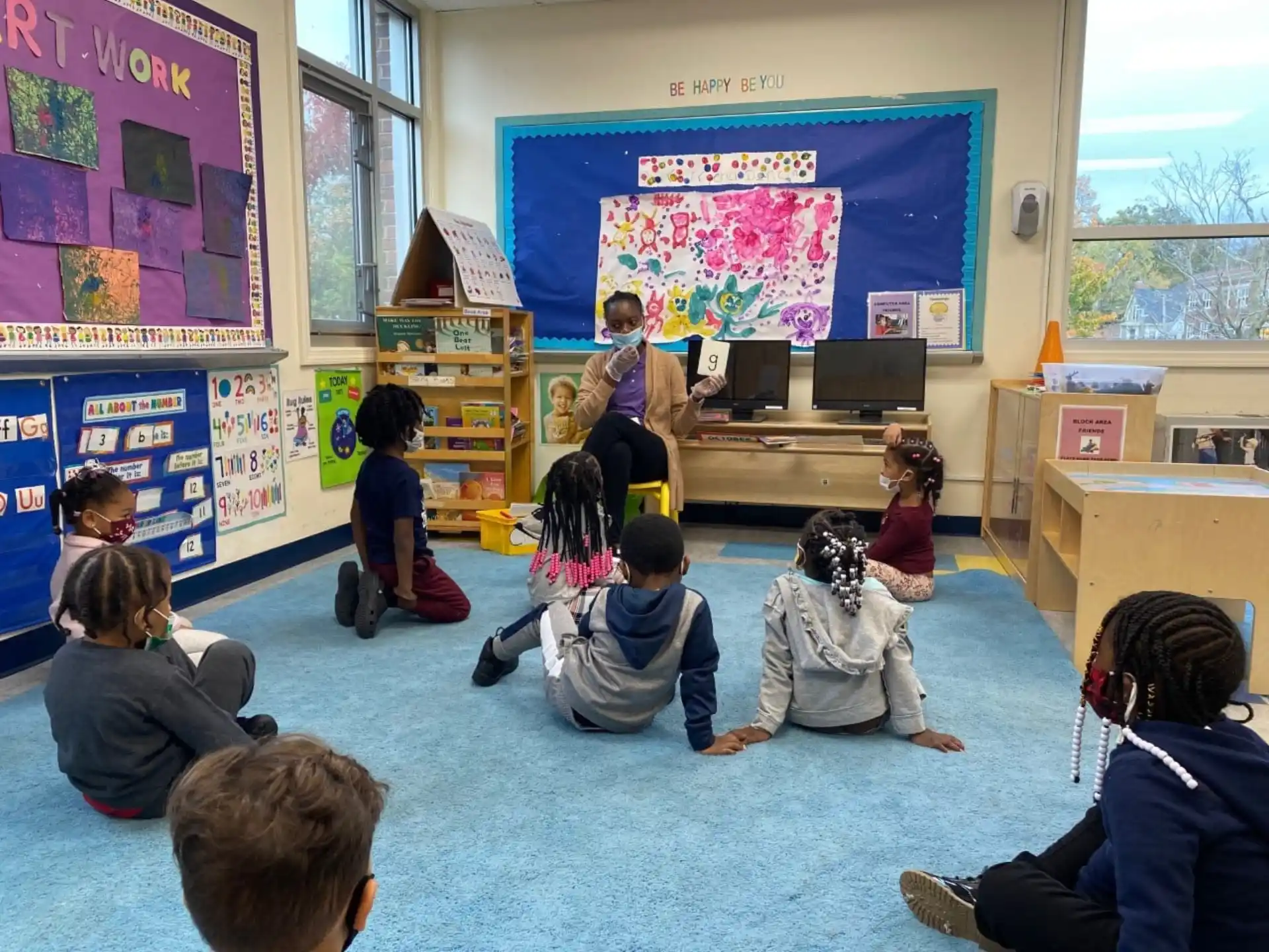 a group of children sitting in a classroom
