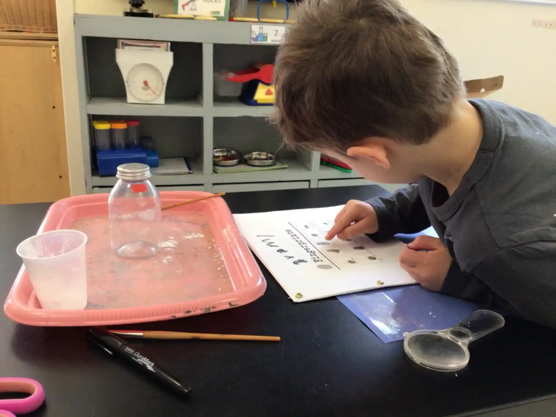 a boy writing on a piece of paper