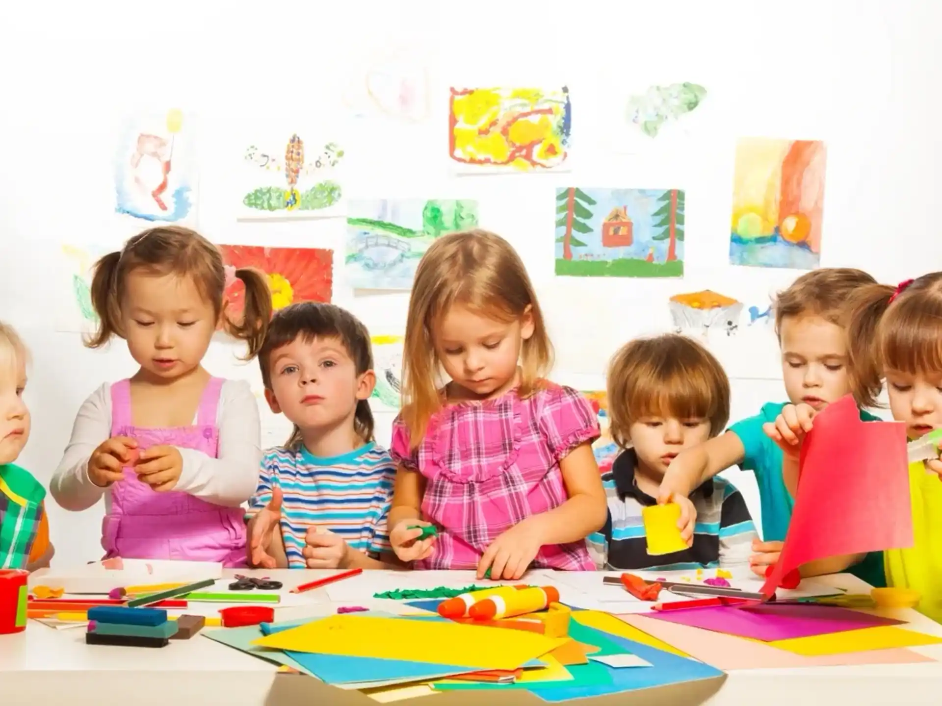 a group of children sitting at a table