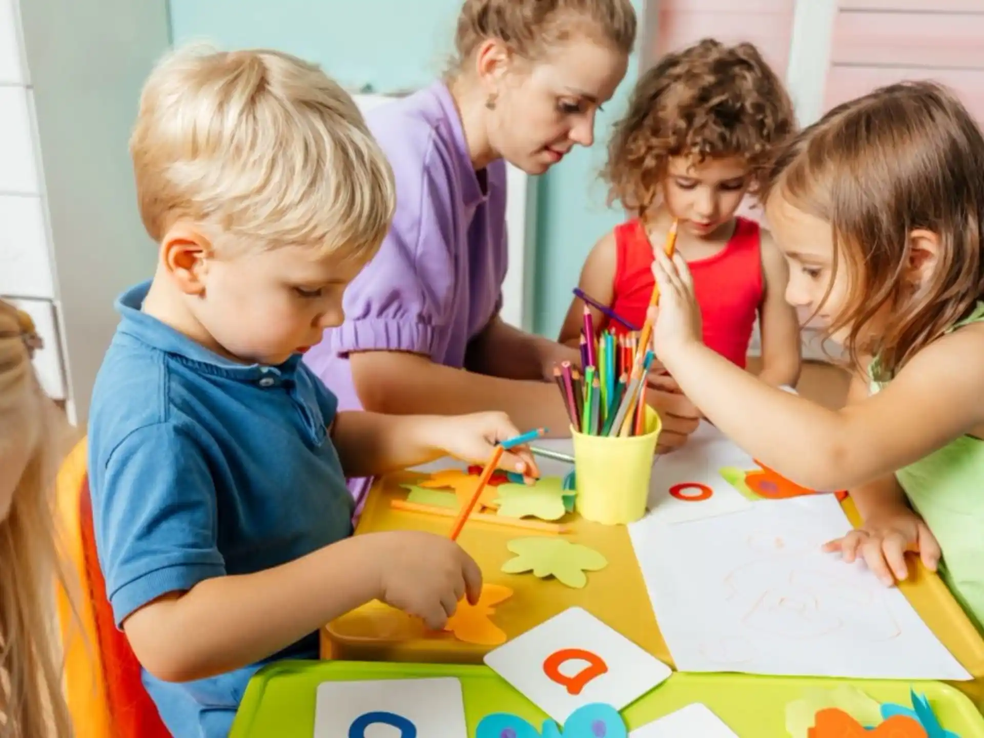 a group of children sitting at a table